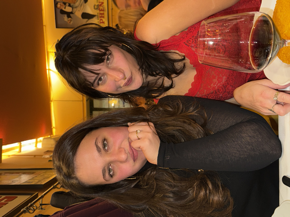 Two women enjoy dinner and laughter at Milan restaurant