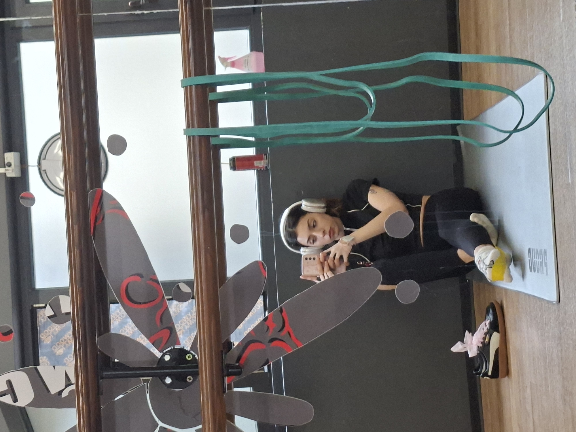 Woman records selfie on yoga mat with headphones