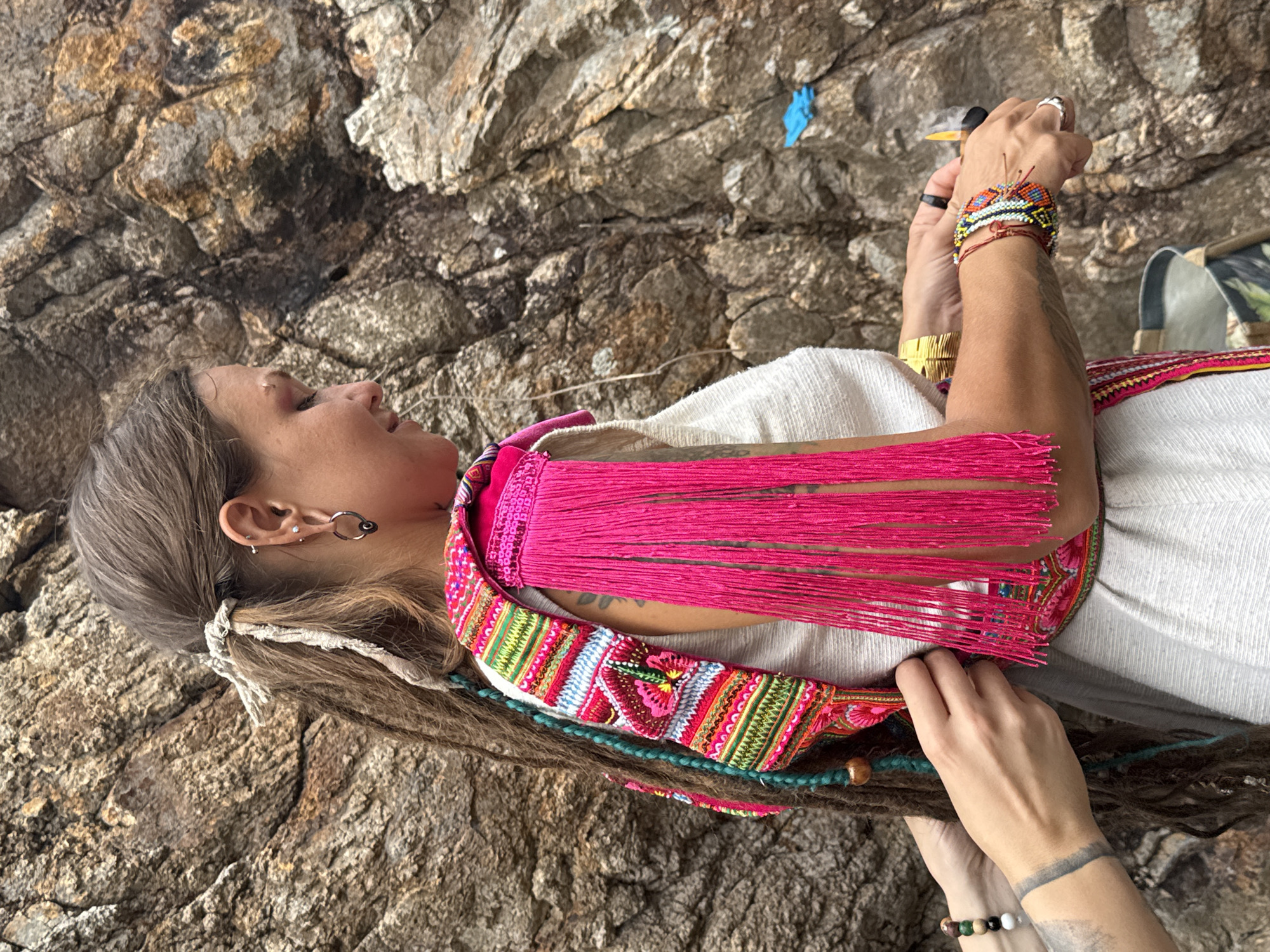 Woman explores coastal cliffs of Koh Phangan during overcast morning
