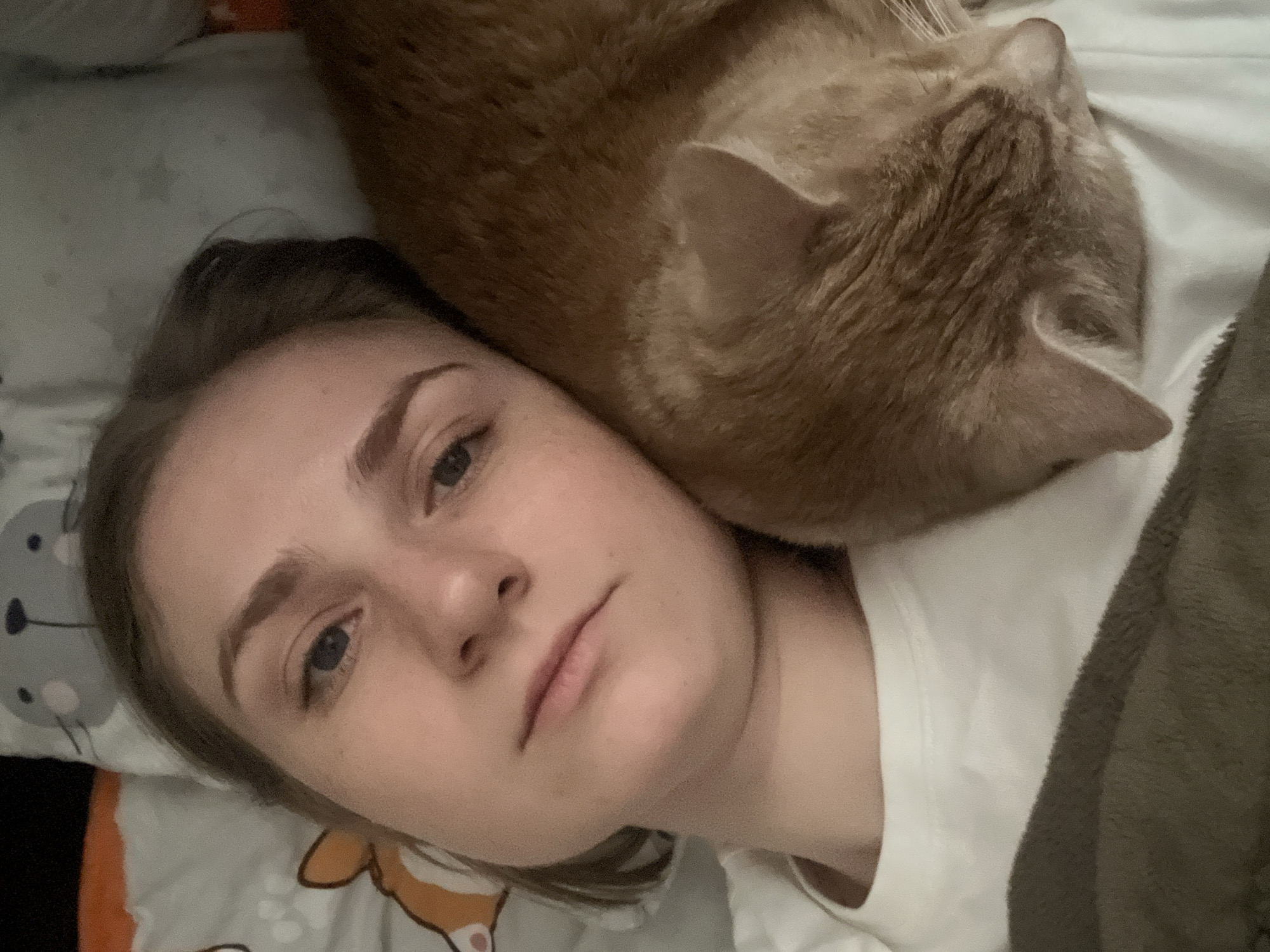 Woman and orange cat share quiet moment in Novosibirsk