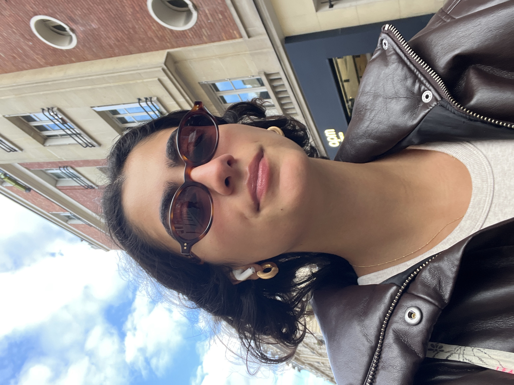 Young person takes selfie in Paris on cloudy afternoon