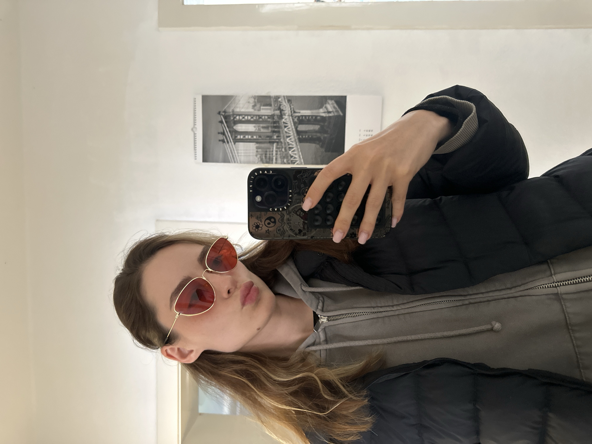 Young woman takes selfies around Kiel in grey hoodie