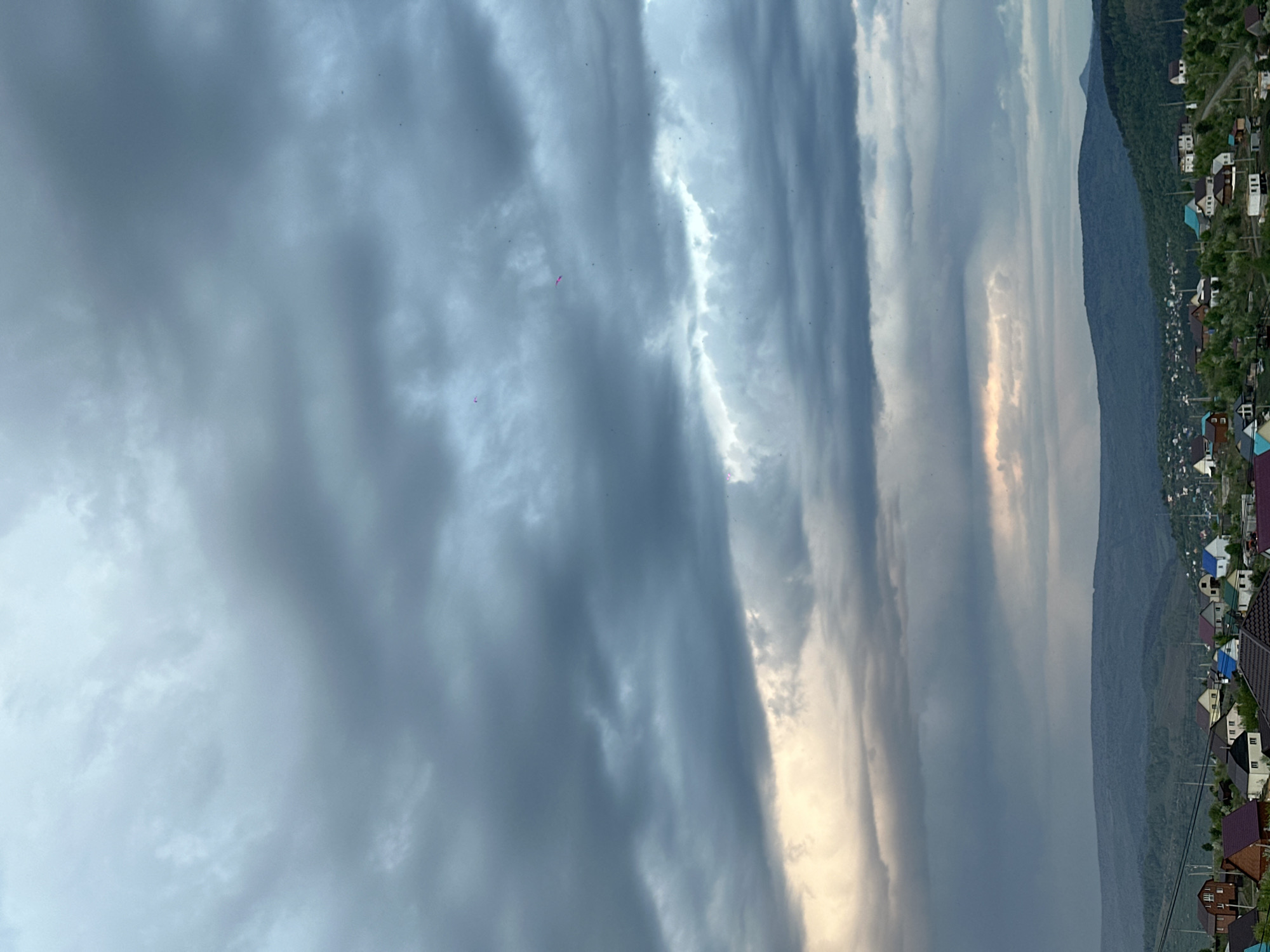 Heavy clouds with filtered sunlight observed over Gorno-Altaysk mountains