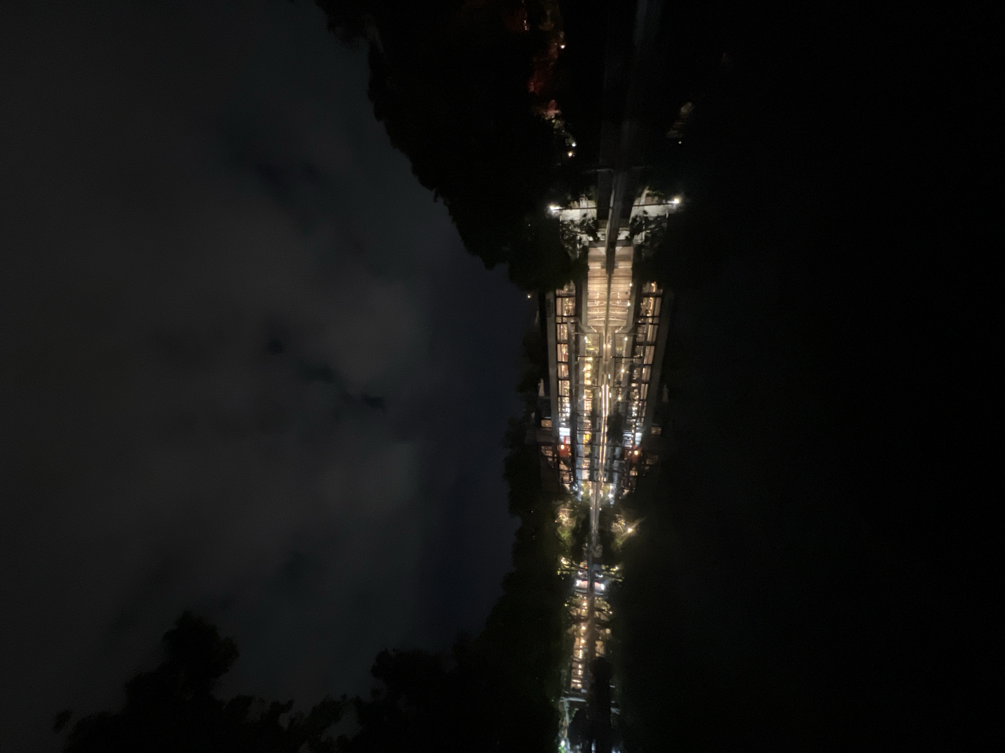 Illuminated building reflects in water during Yerevan night scene