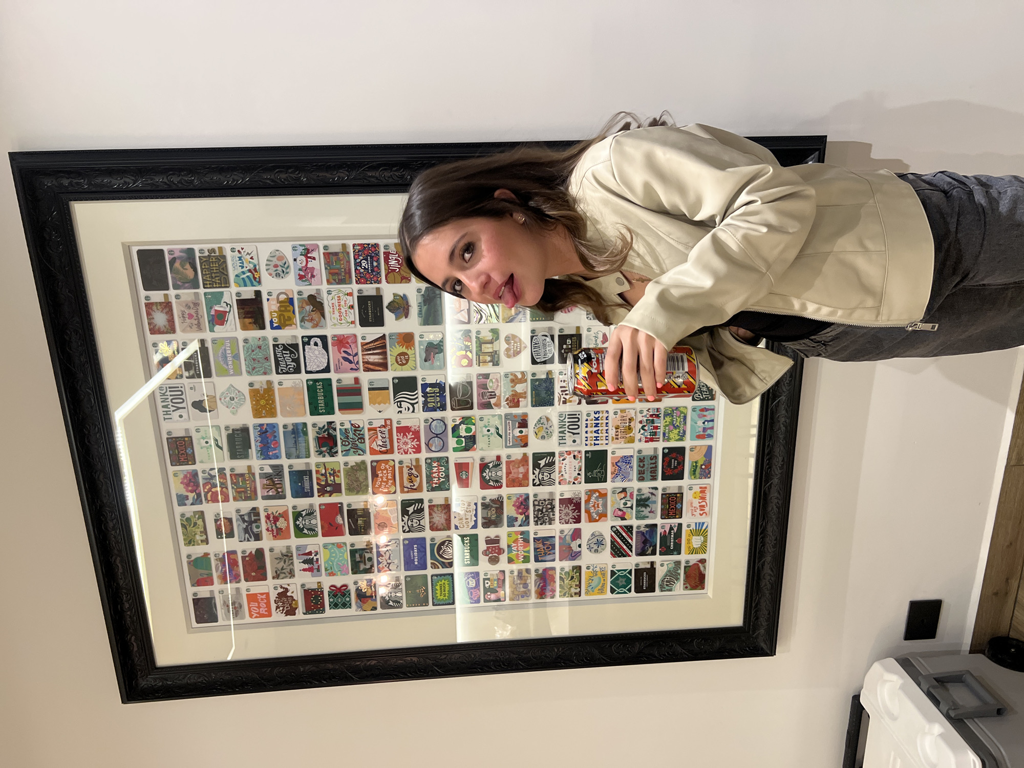 Woman poses playfully before grid artwork indoors