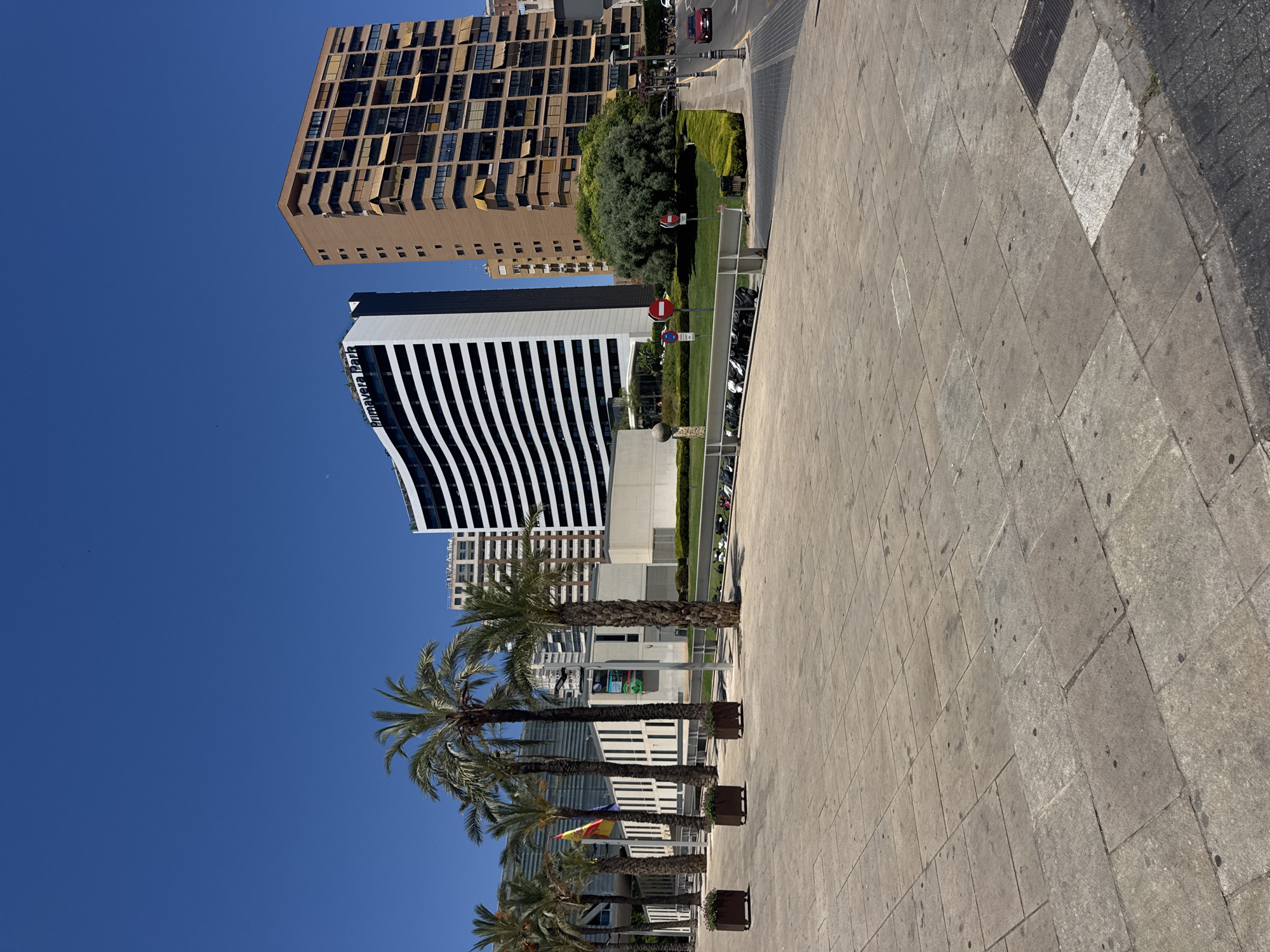 Sunny afternoon on a Benidorm street with cafés and modern buildings