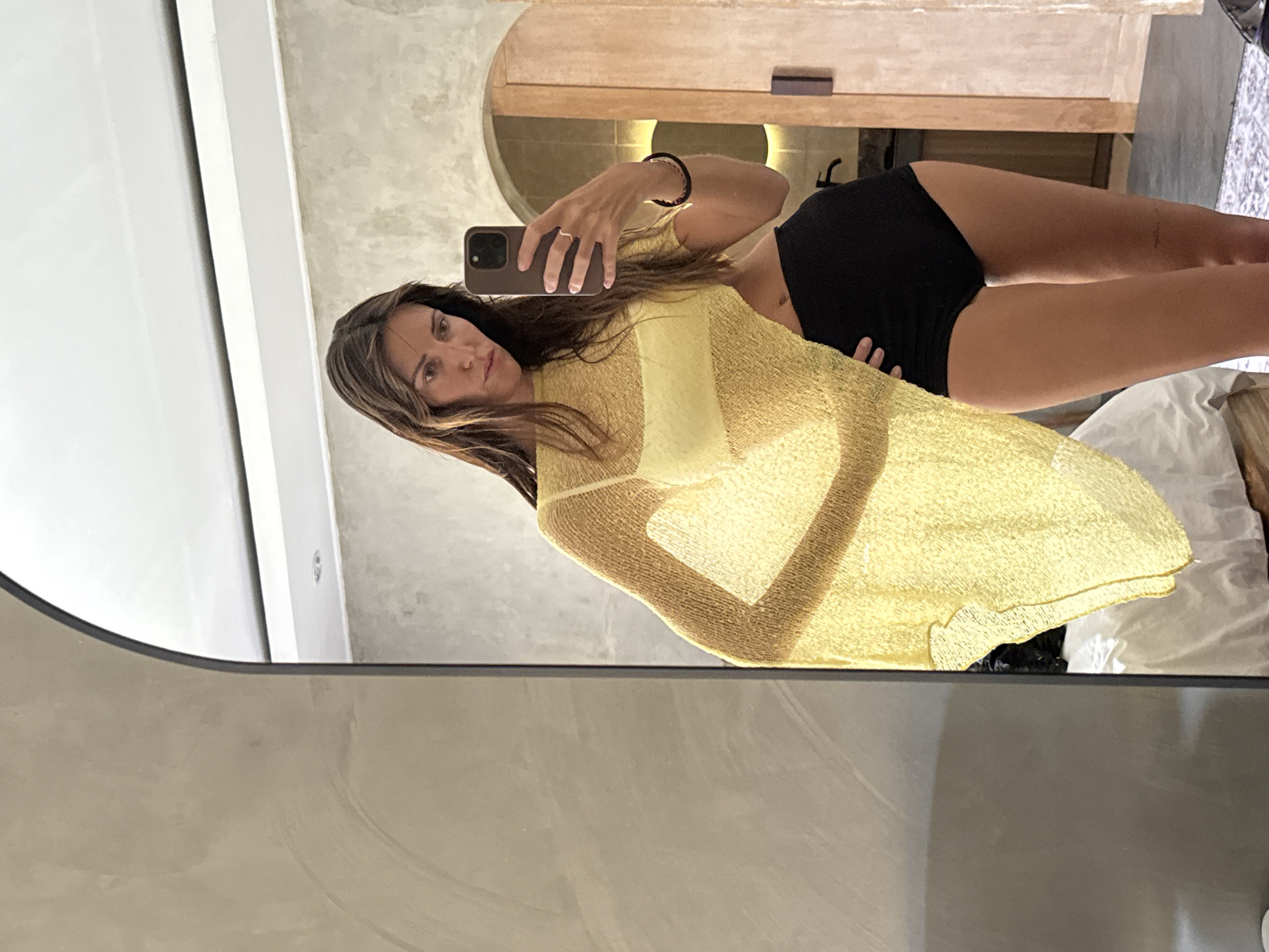 Hotel mirror selfie in a yellow beach look, North Kuta