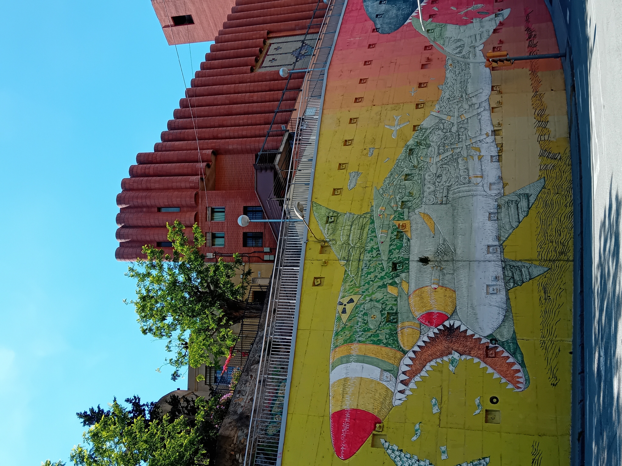 Street mural depicts money shark in Barcelona