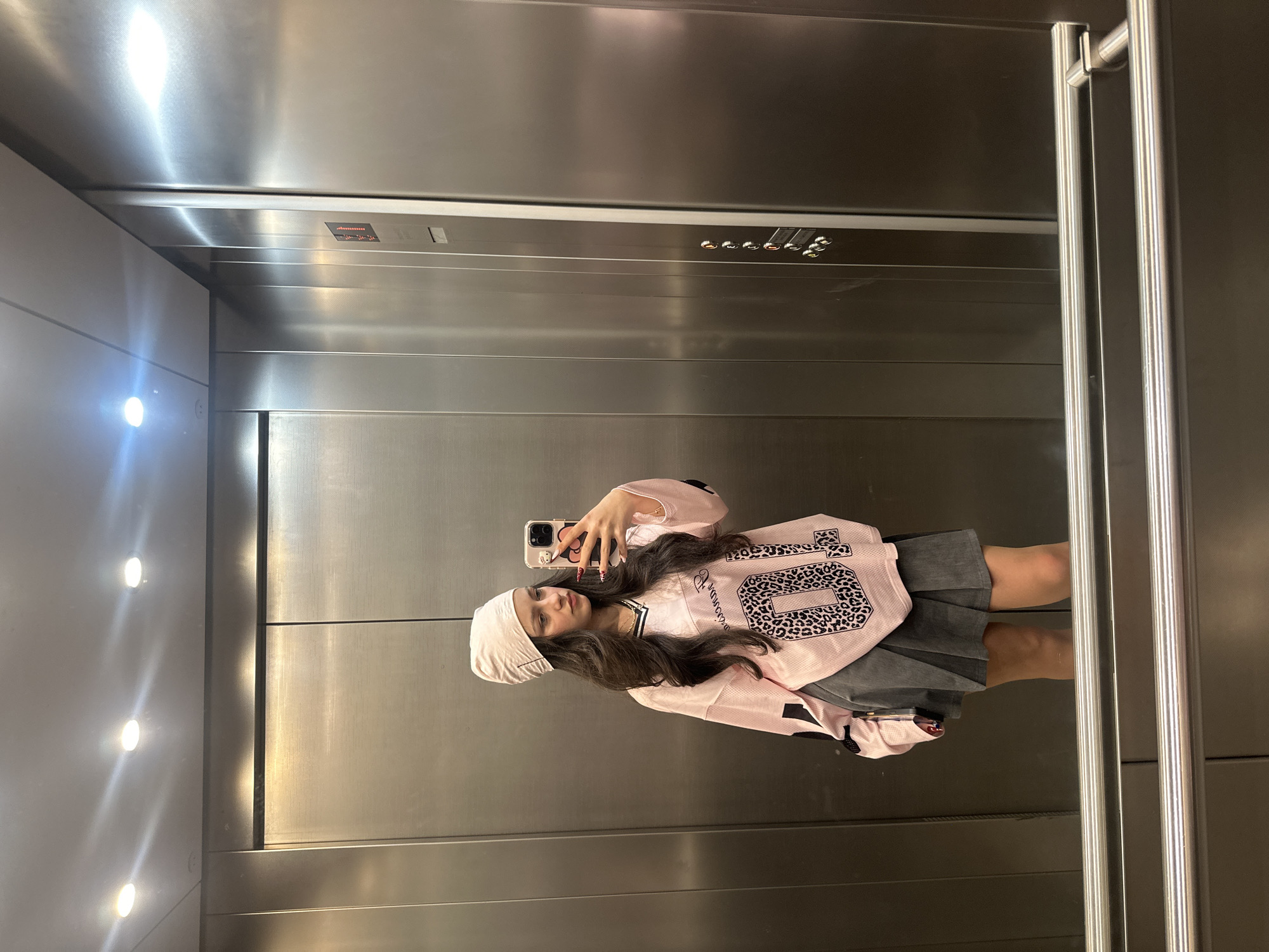 Woman takes elevator selfies in Yerevan during overcast evening