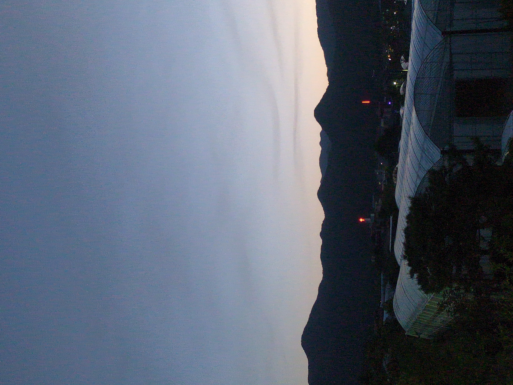 Twilight scene with mountains and modern architecture captured in Iwon