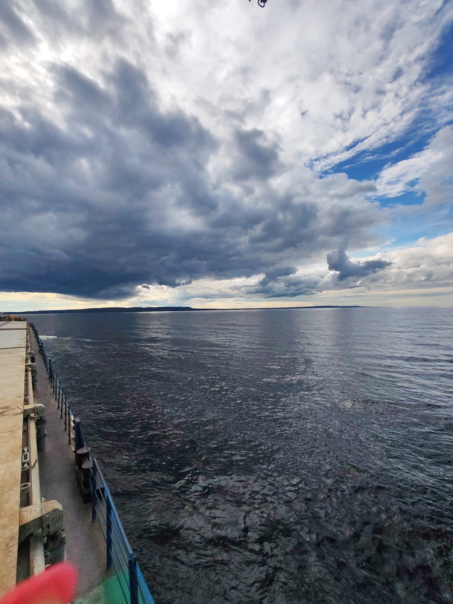 On deck, crossing dark Russian waters under a moody sky