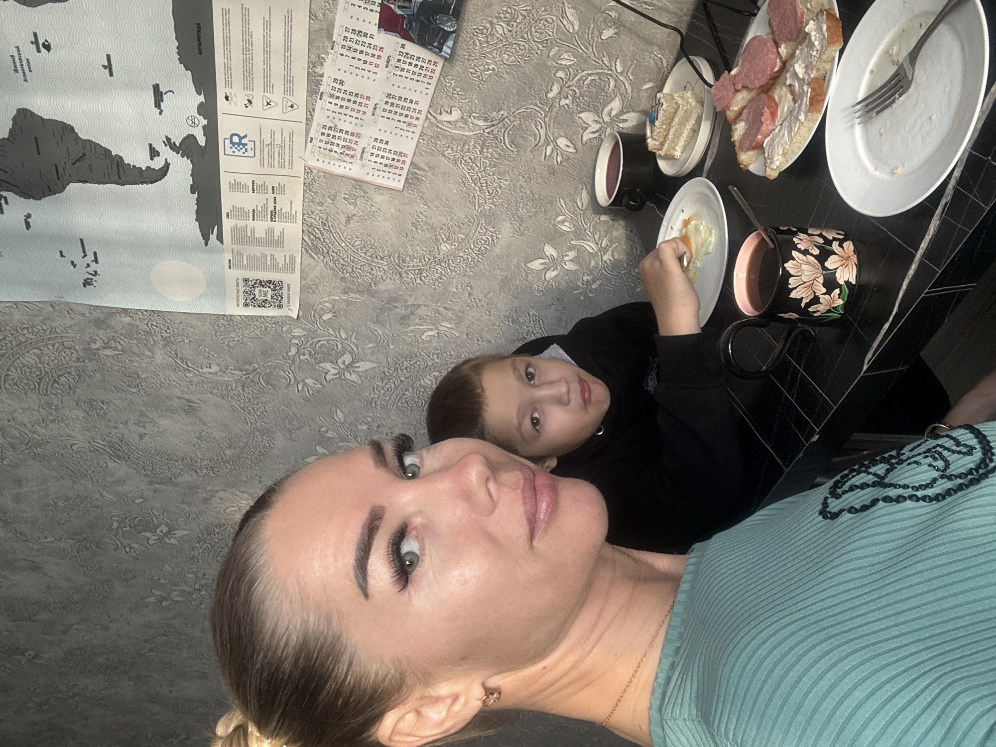 Woman takes selfies during breakfast with boy in Abakan