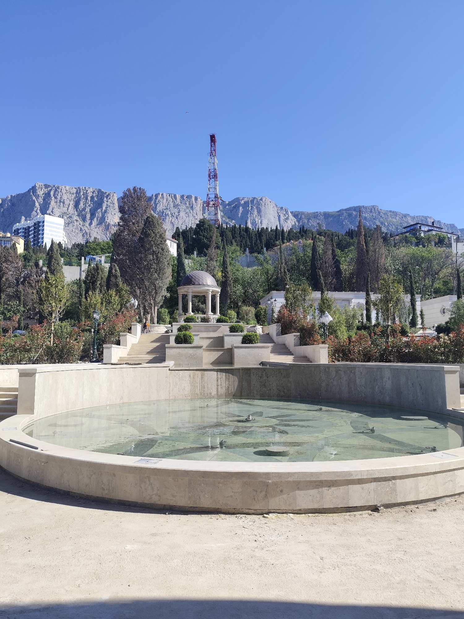 Empty stone fountain observed in Ukrainian park setting