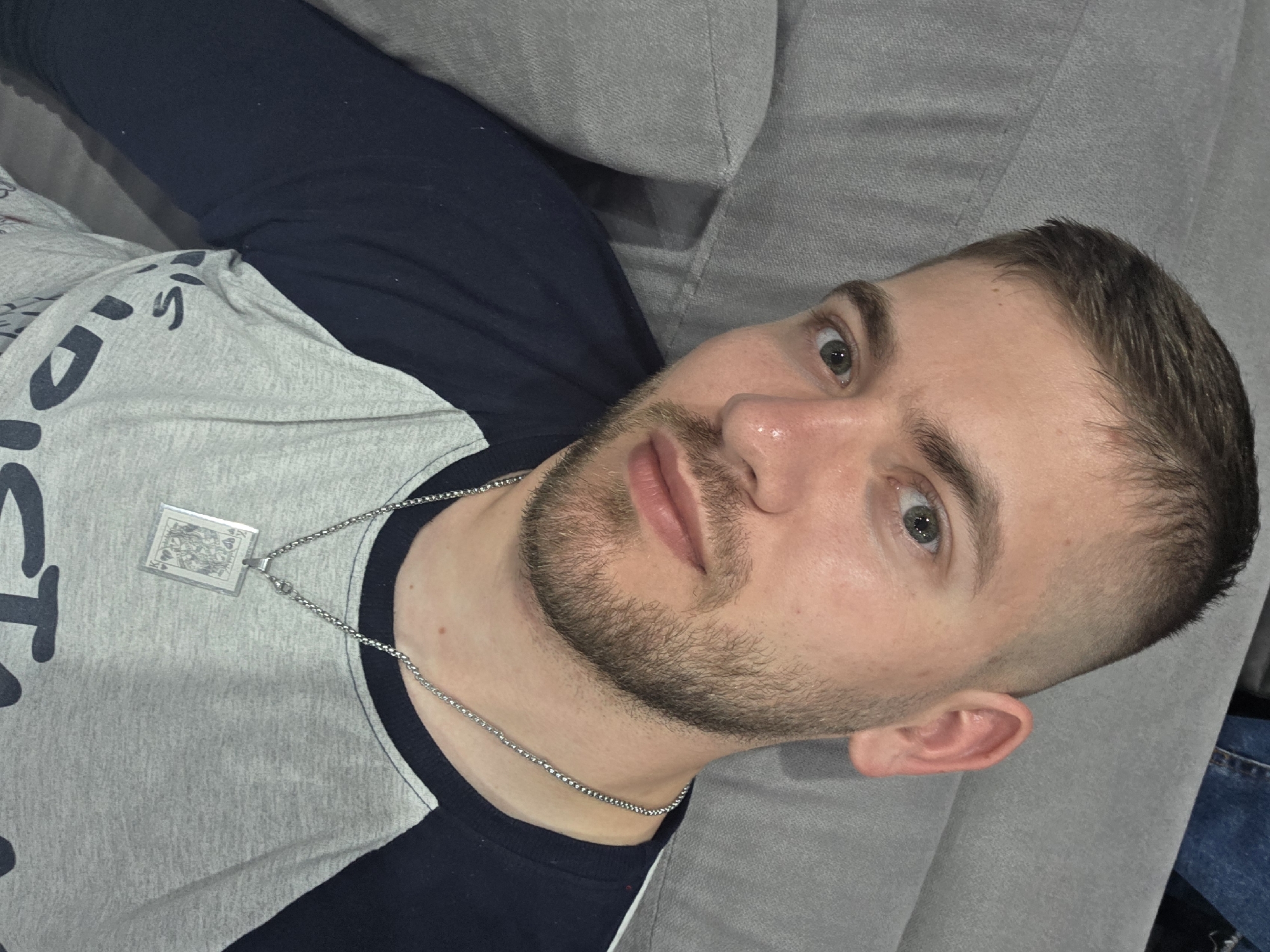 Man relaxes on sofa in Yagodovo home