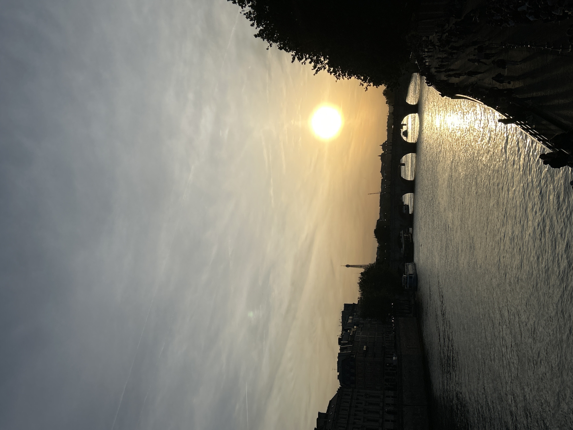 Golden hour sunset documented along Seine River in Paris