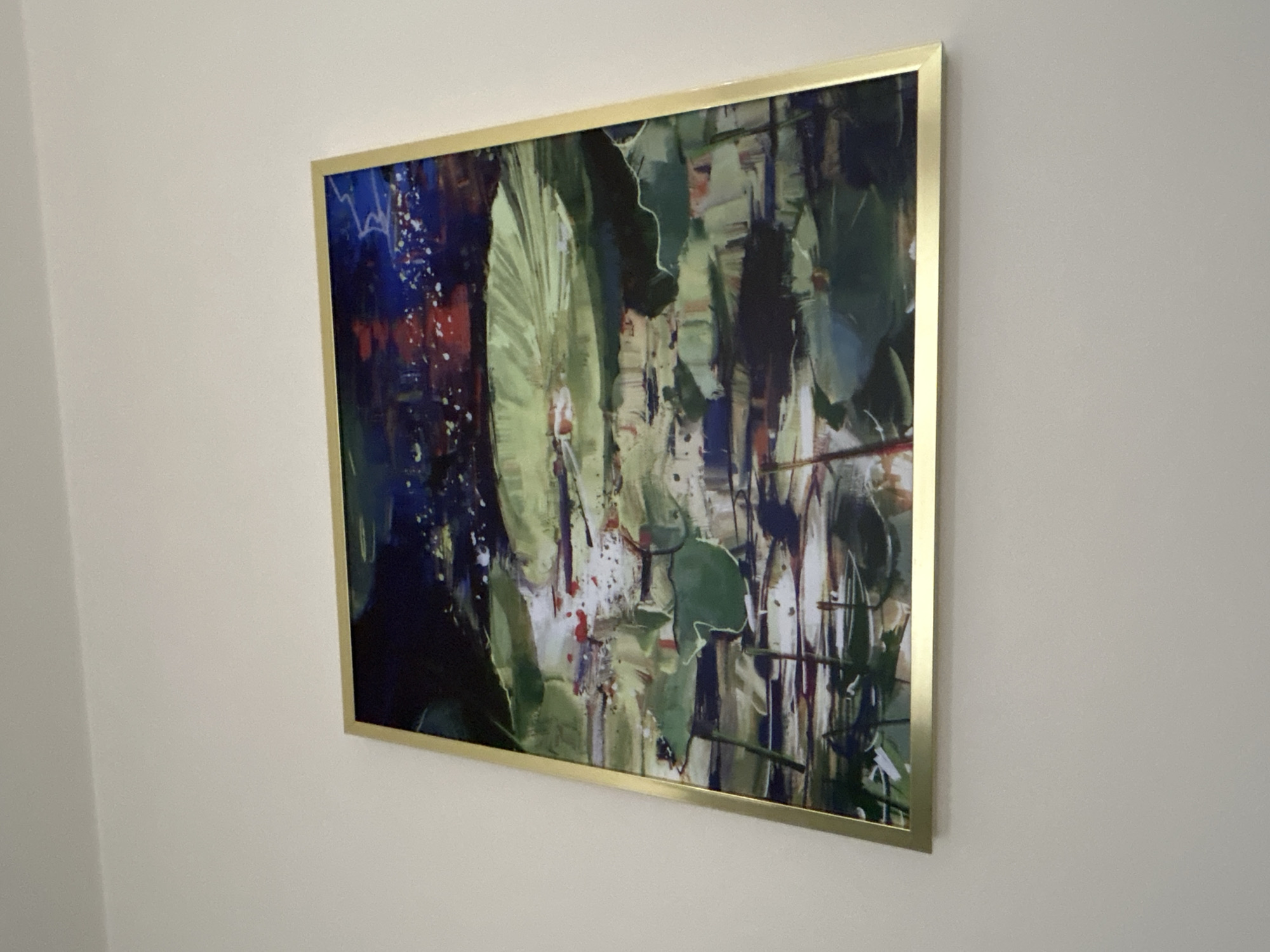 Man photographed near abstract painting in Warsaw indoor setting