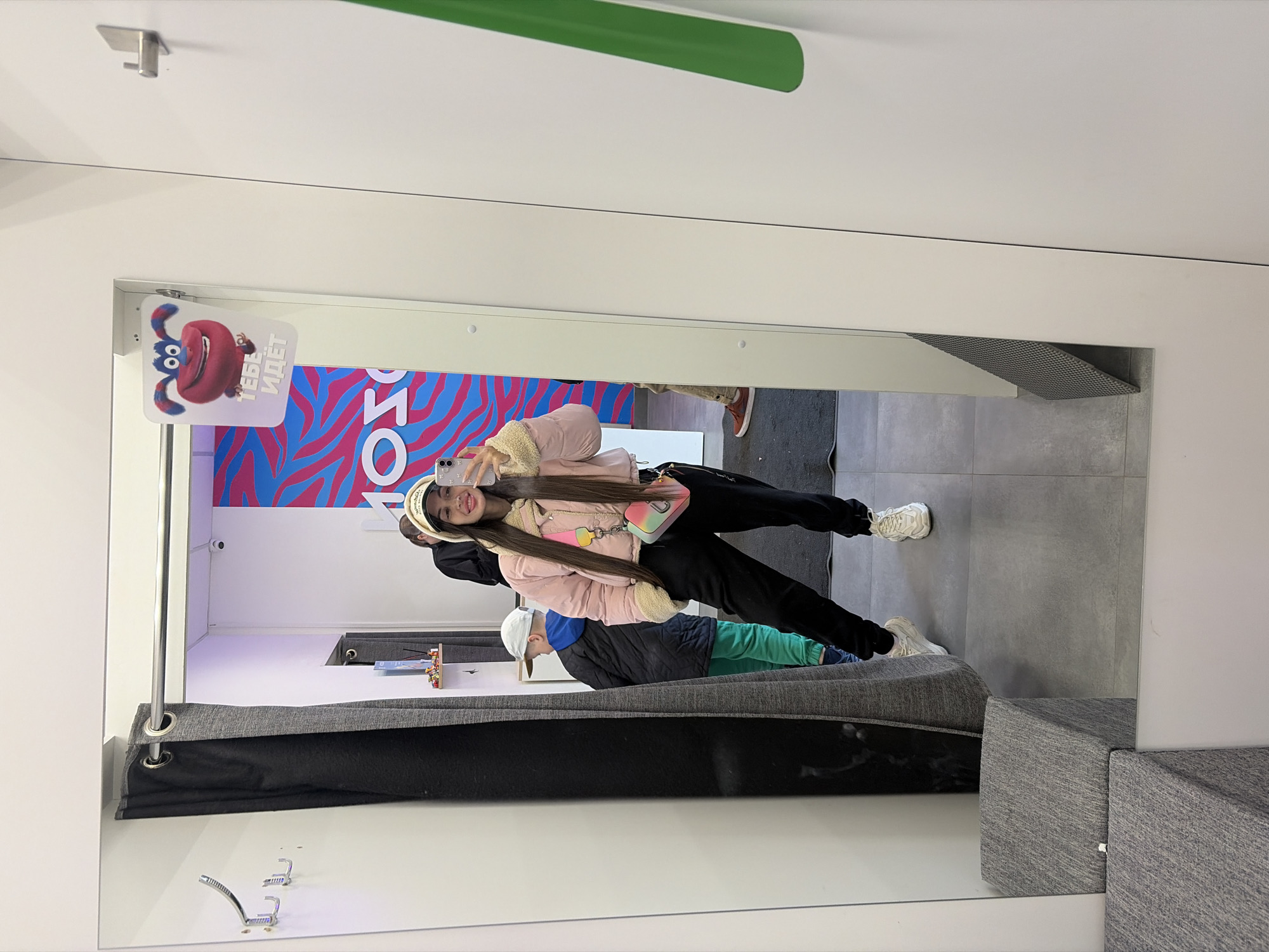 Woman takes fitting room selfie with child in Saint Petersburg