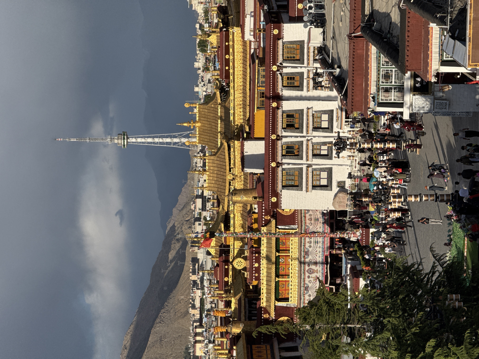 Pilgrims carry prayer wheels near Potala Palace in Lhasa