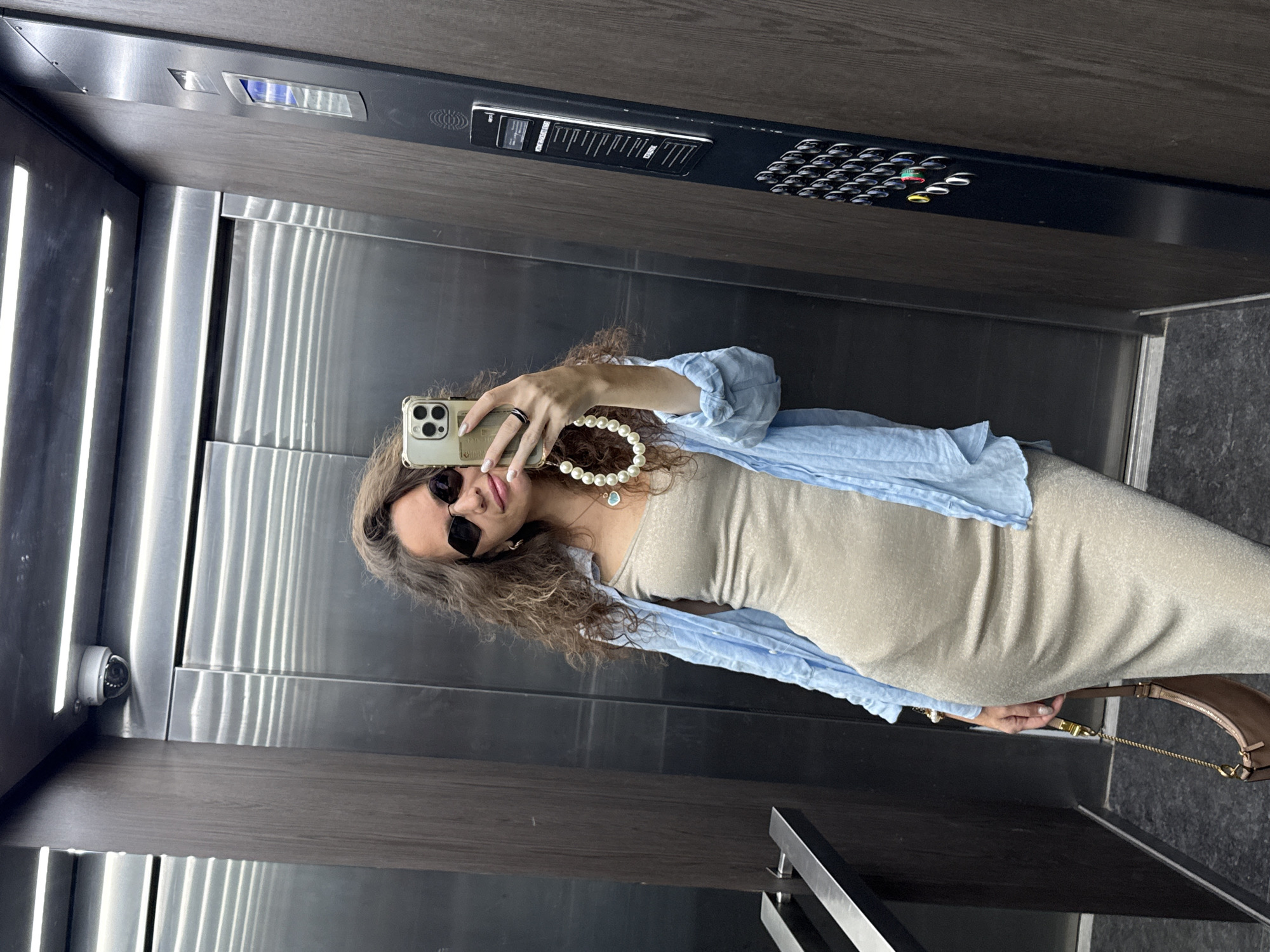 Elevator selfie with a pearl phone charm, Moscow