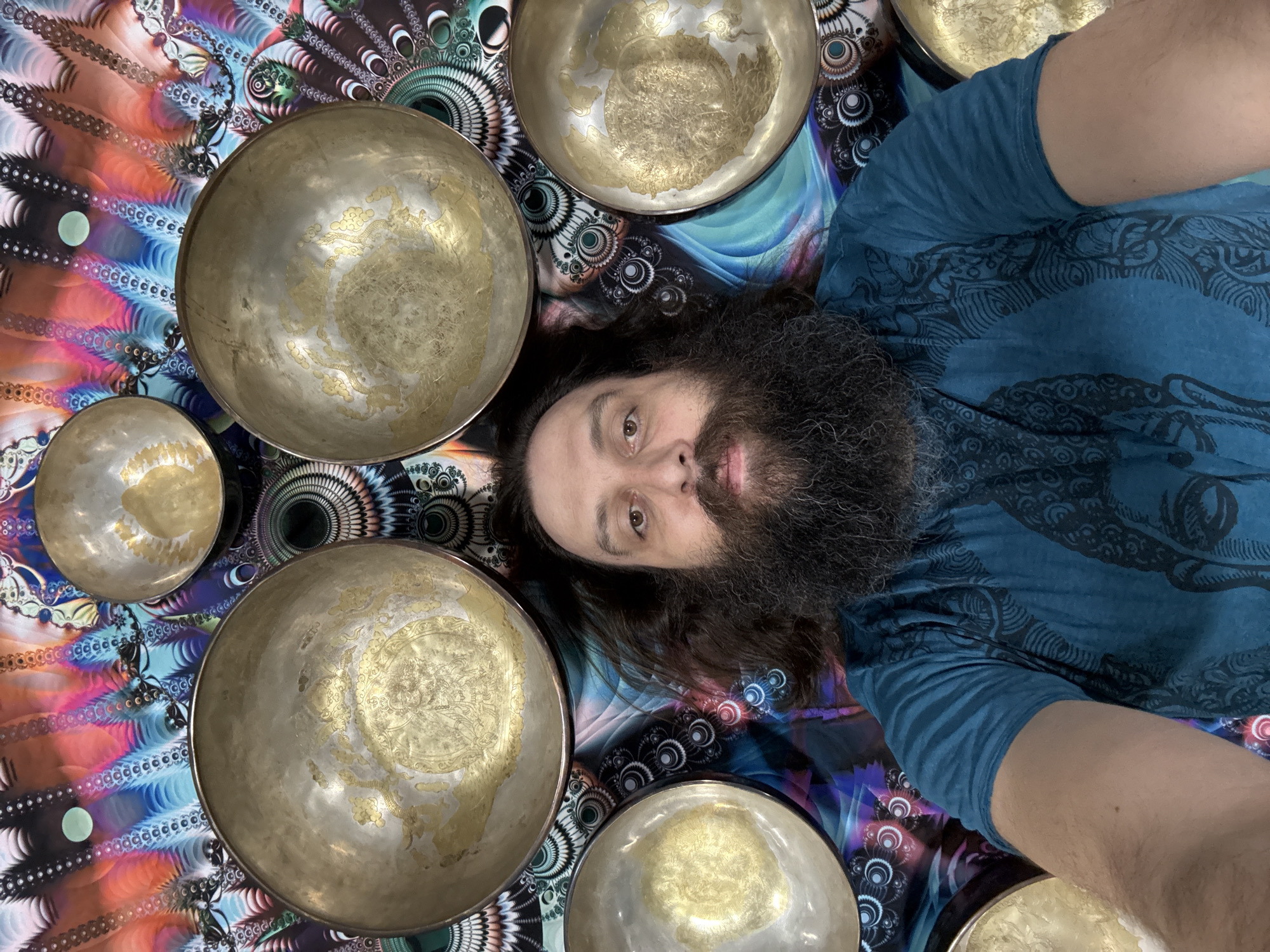 Man poses with brass singing bowls in Tashkent