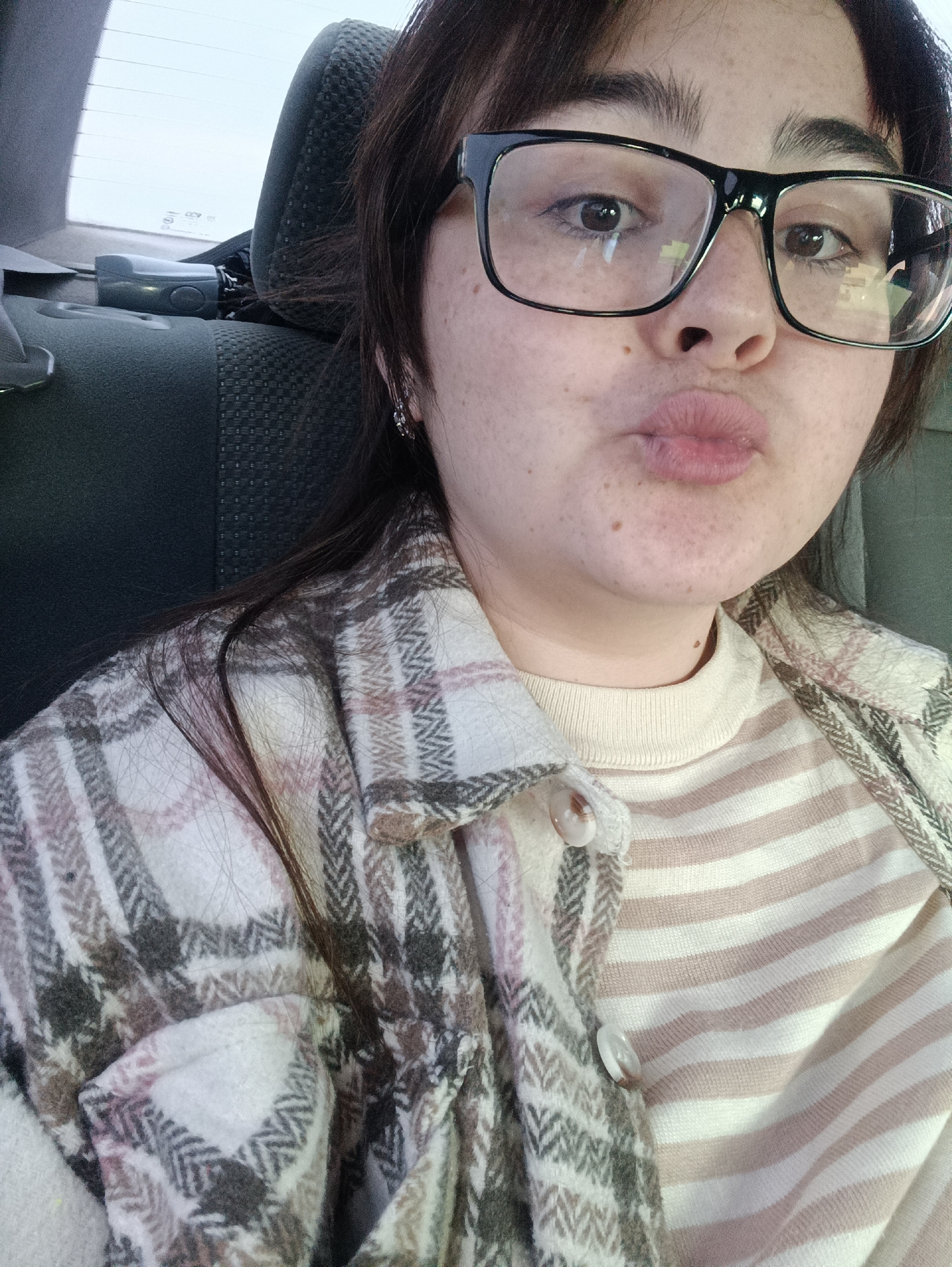 Woman in glasses observed in car backseat in Chaikovsky