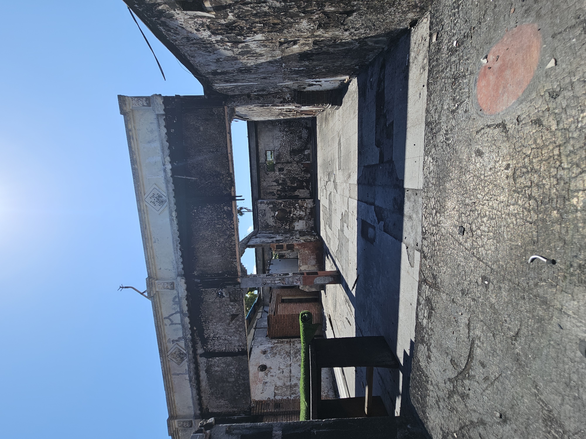 Dive shop, fire damage, and street activity on one Denpasar block