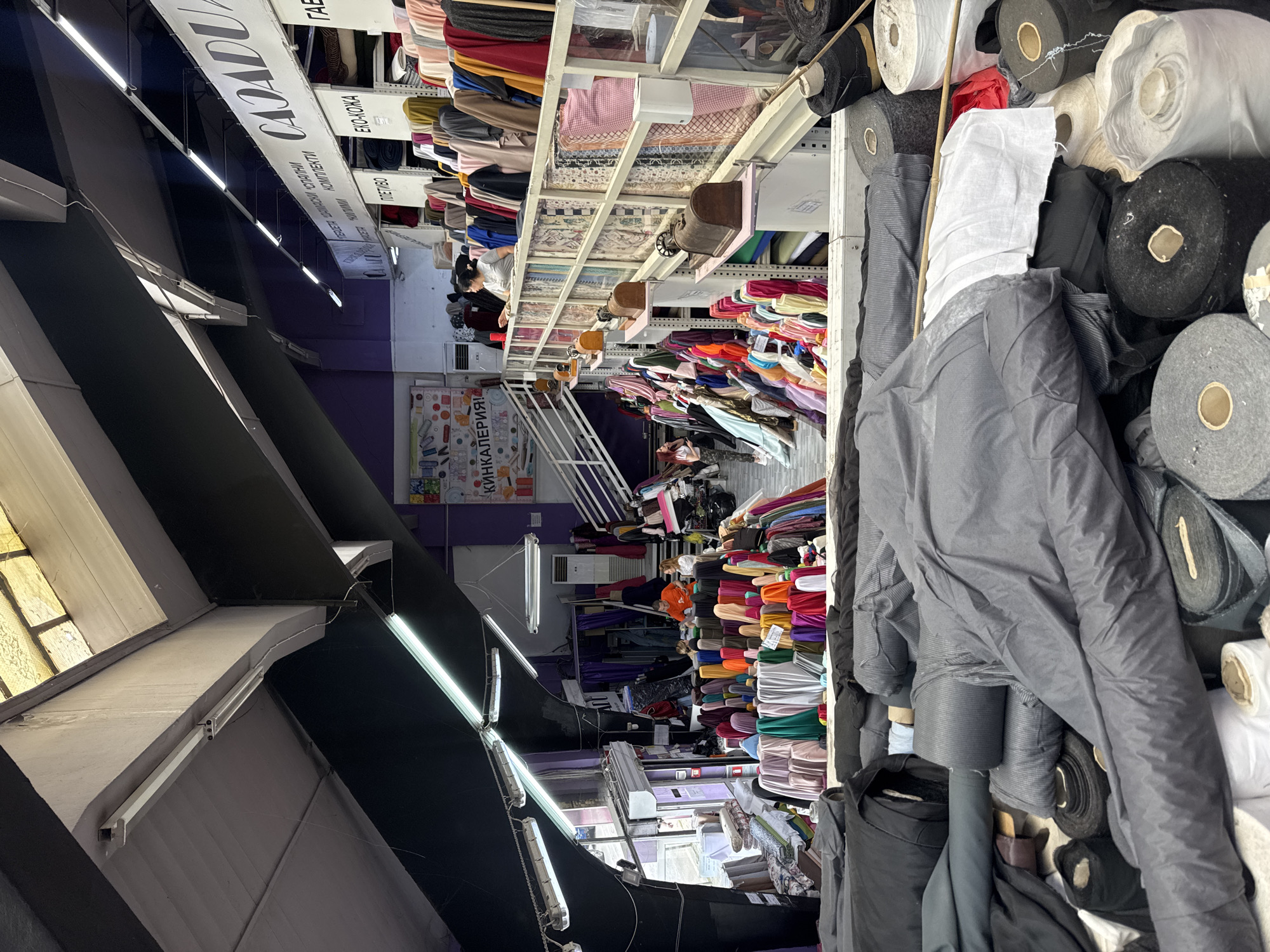 Person documented shopping and note-taking in Sofia fabric stores
