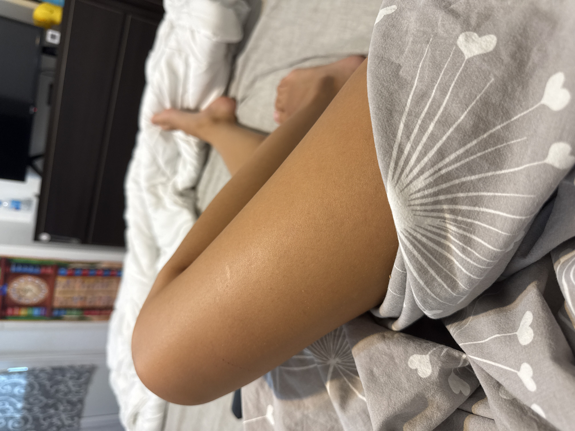 Relaxing on patterned sheets in a Chișinău bedroom