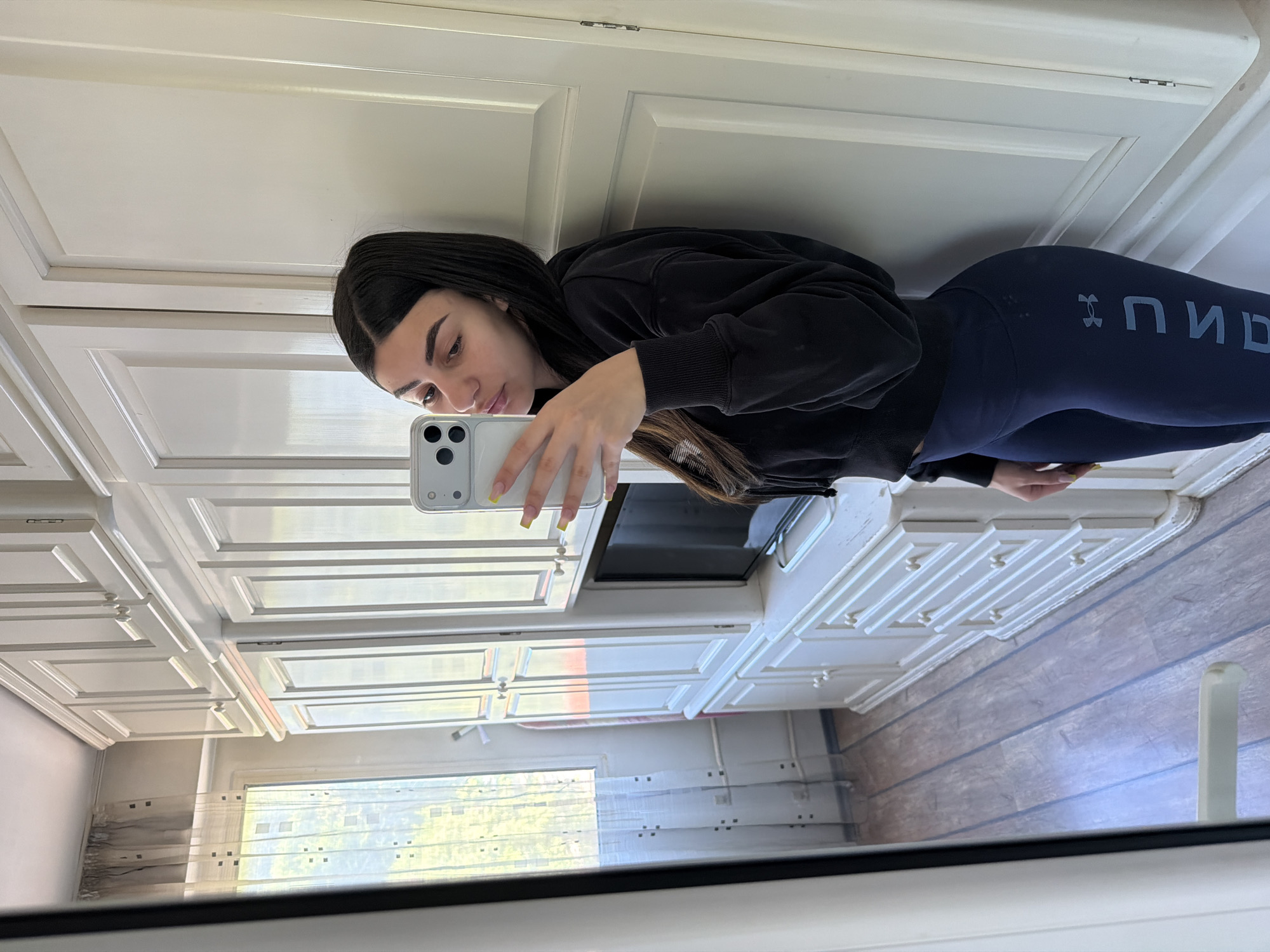 Woman takes mirror selfies in Gabrovo bathroom early morning