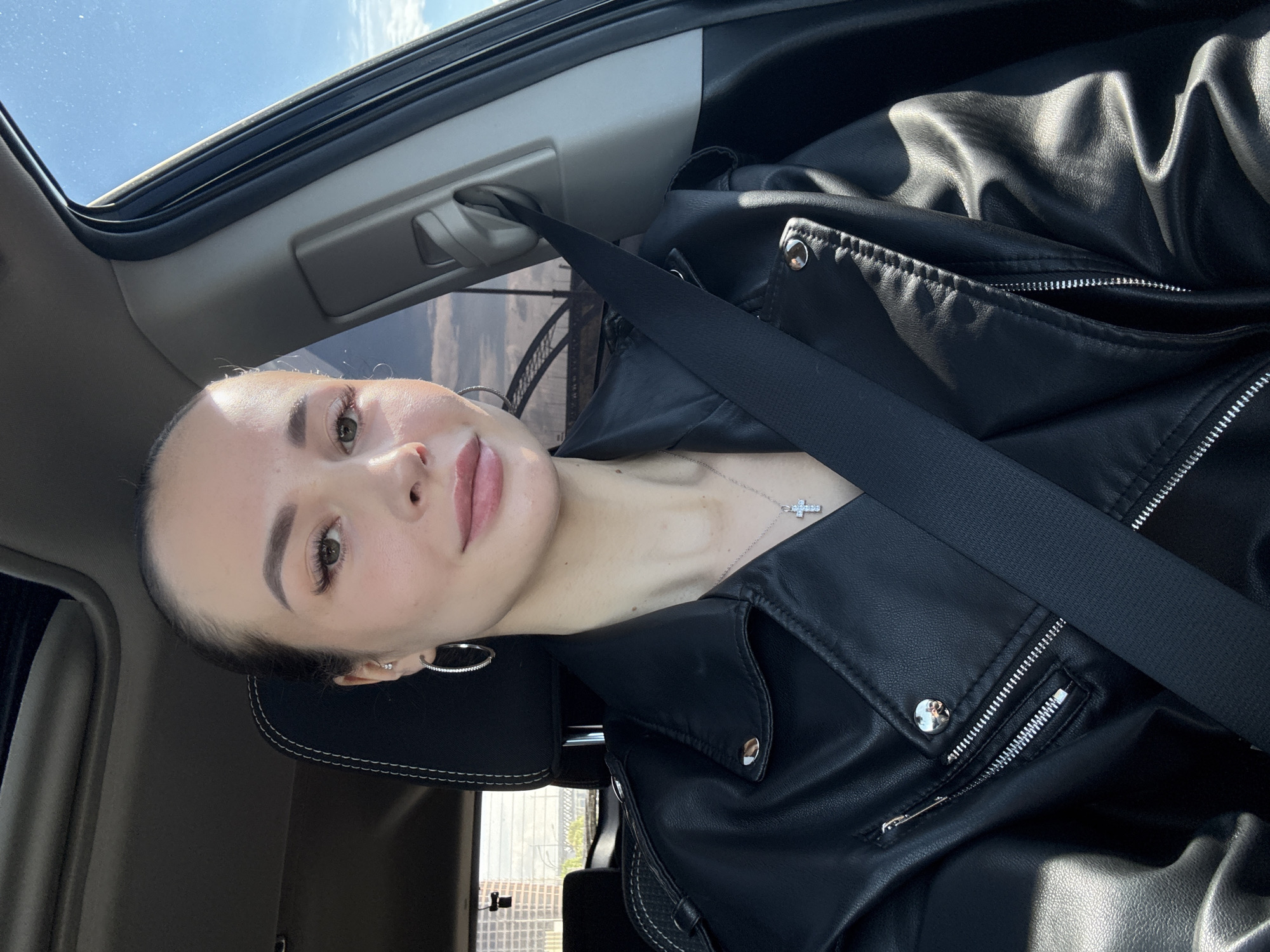 Woman drives through sunny Kyiv morning with sunroof open