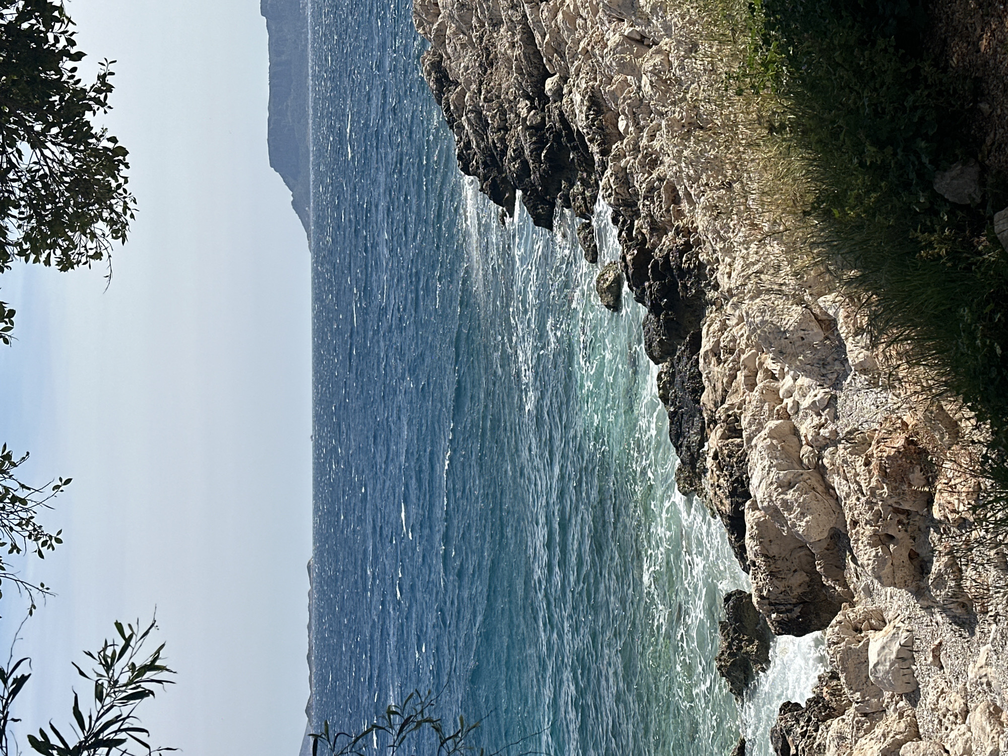 Waves crash against rocky coastline in Kaş, Turkey