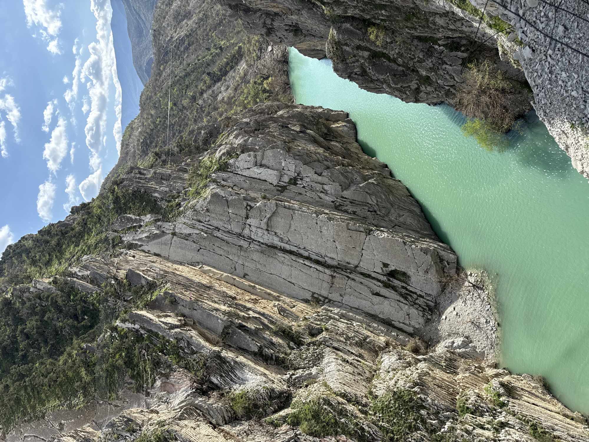 Workers view turquoise canyon river from platform in Russia