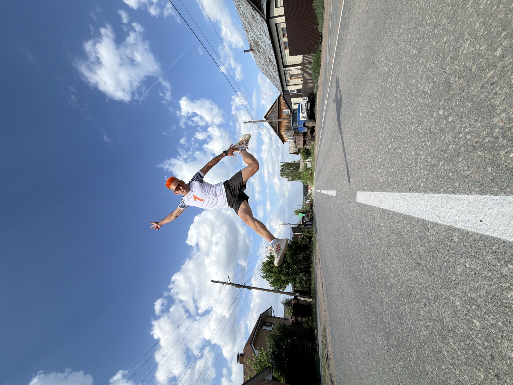 Orange-haired man performs street acrobatics in Chaikovsky, Russia