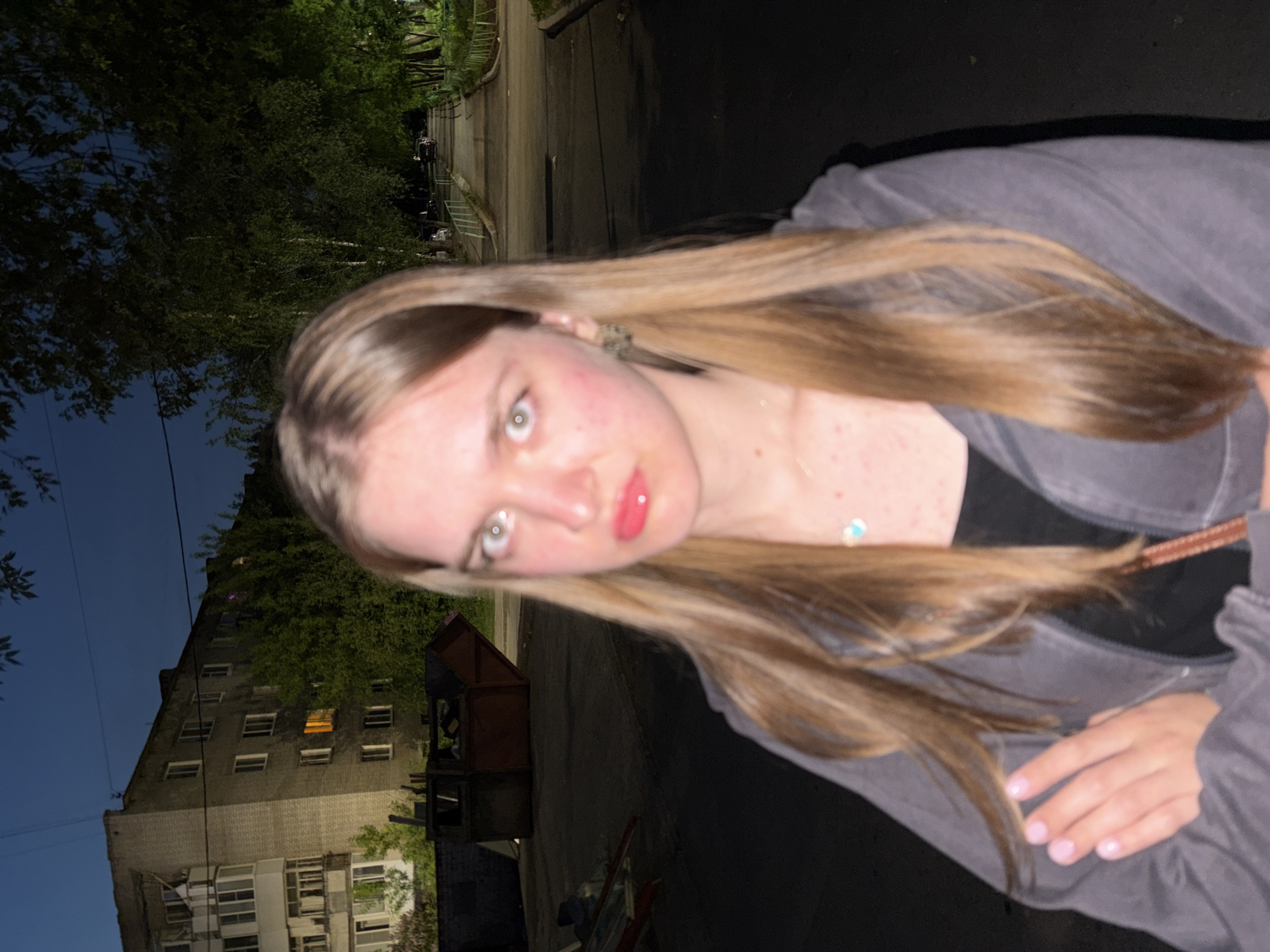 Woman takes evening selfies in residential Perm, Russia