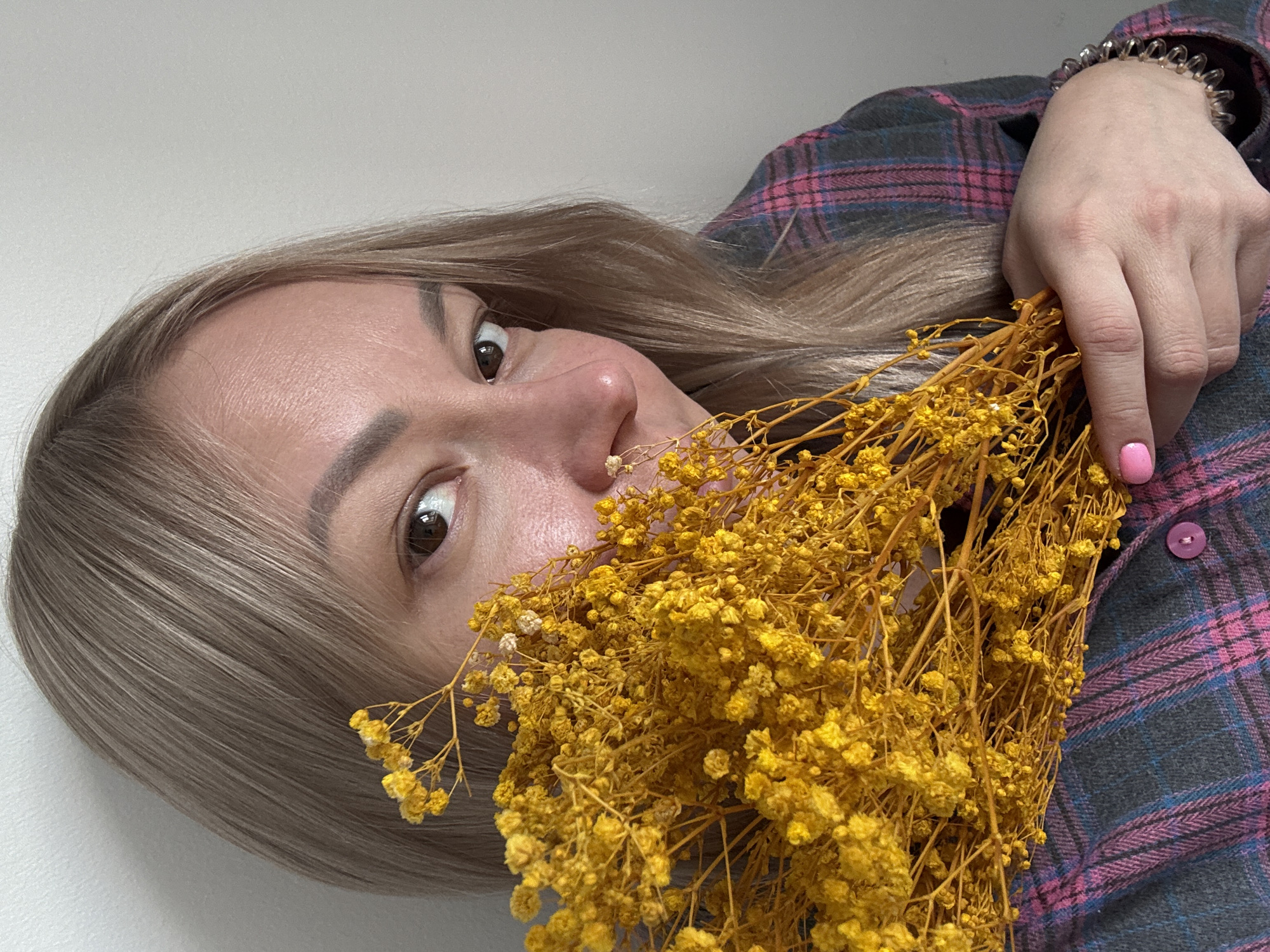 Woman poses with yellow flower bouquet in Izhevsk