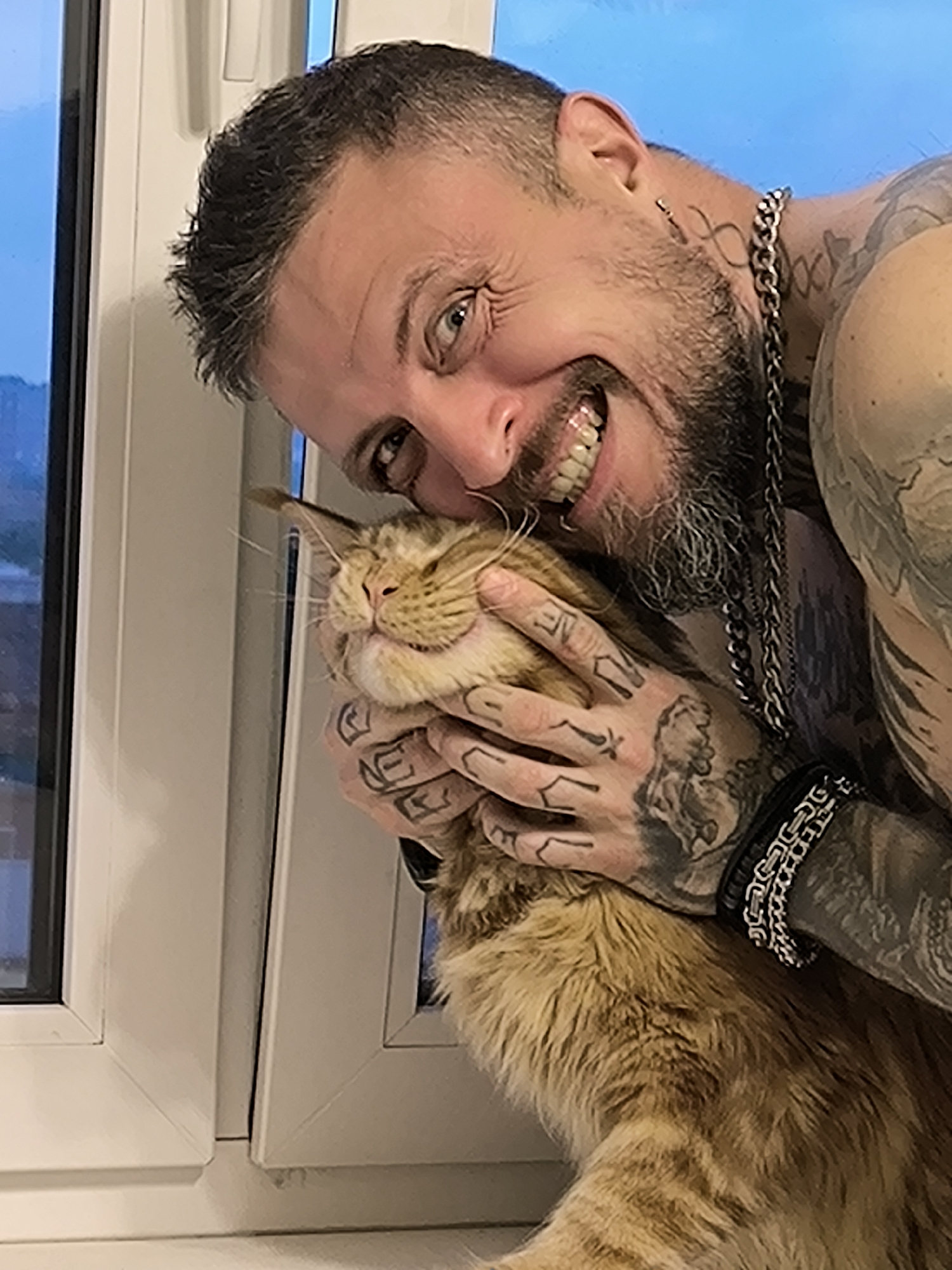 Cat cuddles by window frame in Saint Petersburg