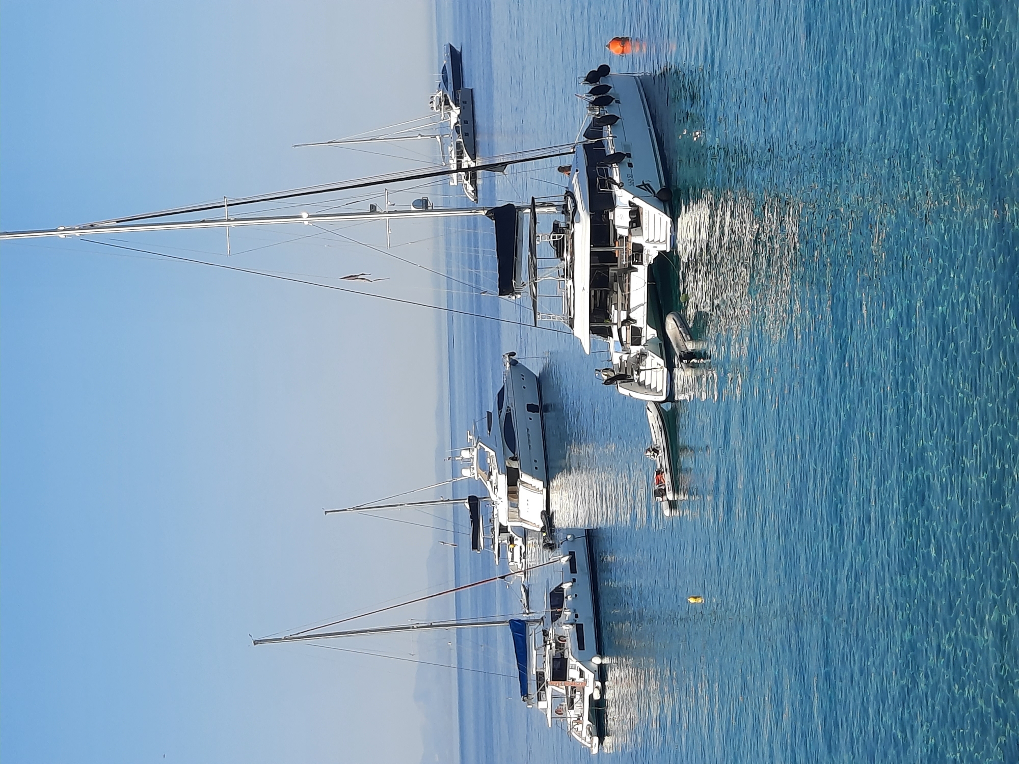 Yachts anchored in the blue waters of Platys Gialos, Greece