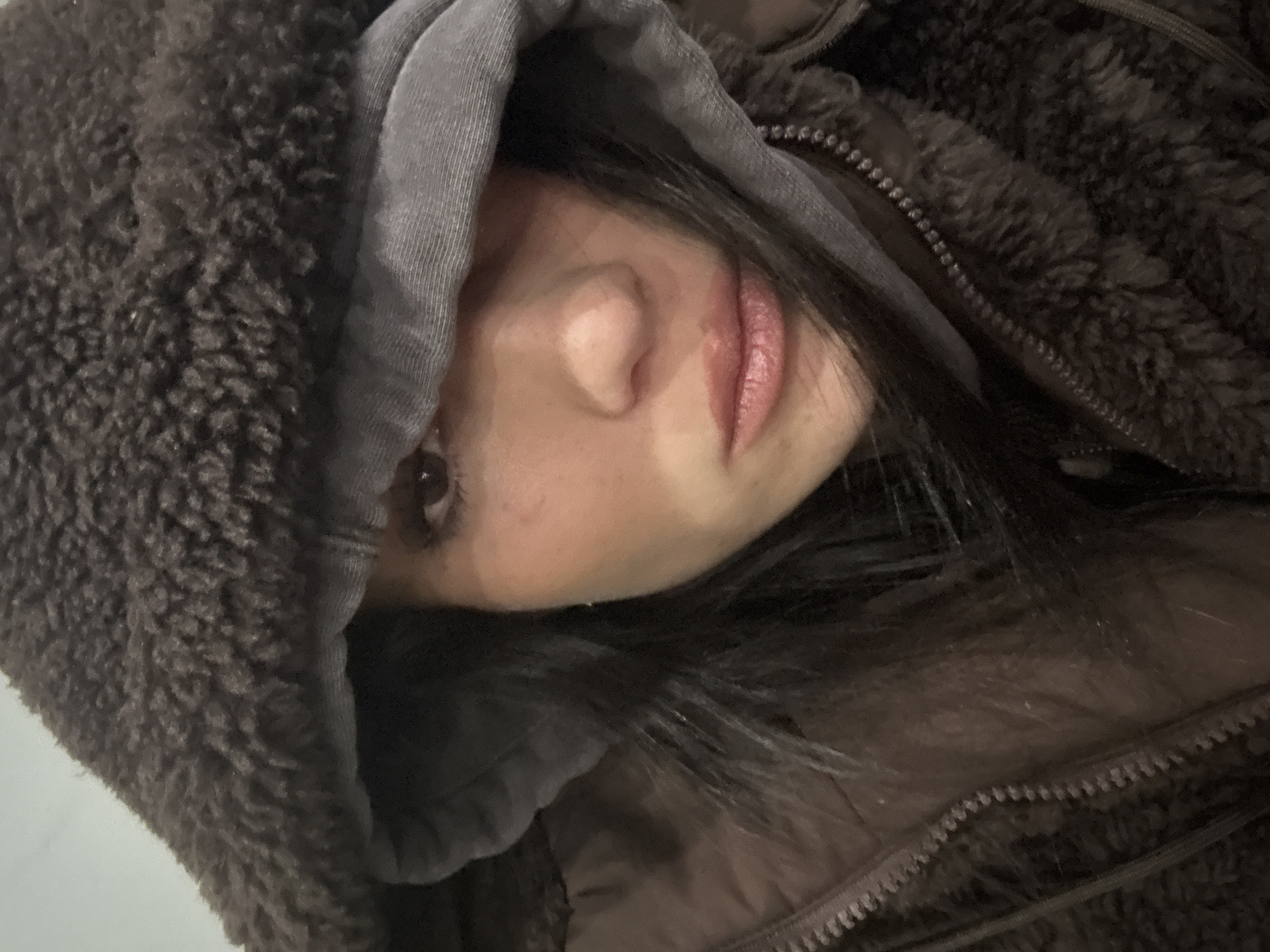Person in brown hoodie photographed in Buenos Aires