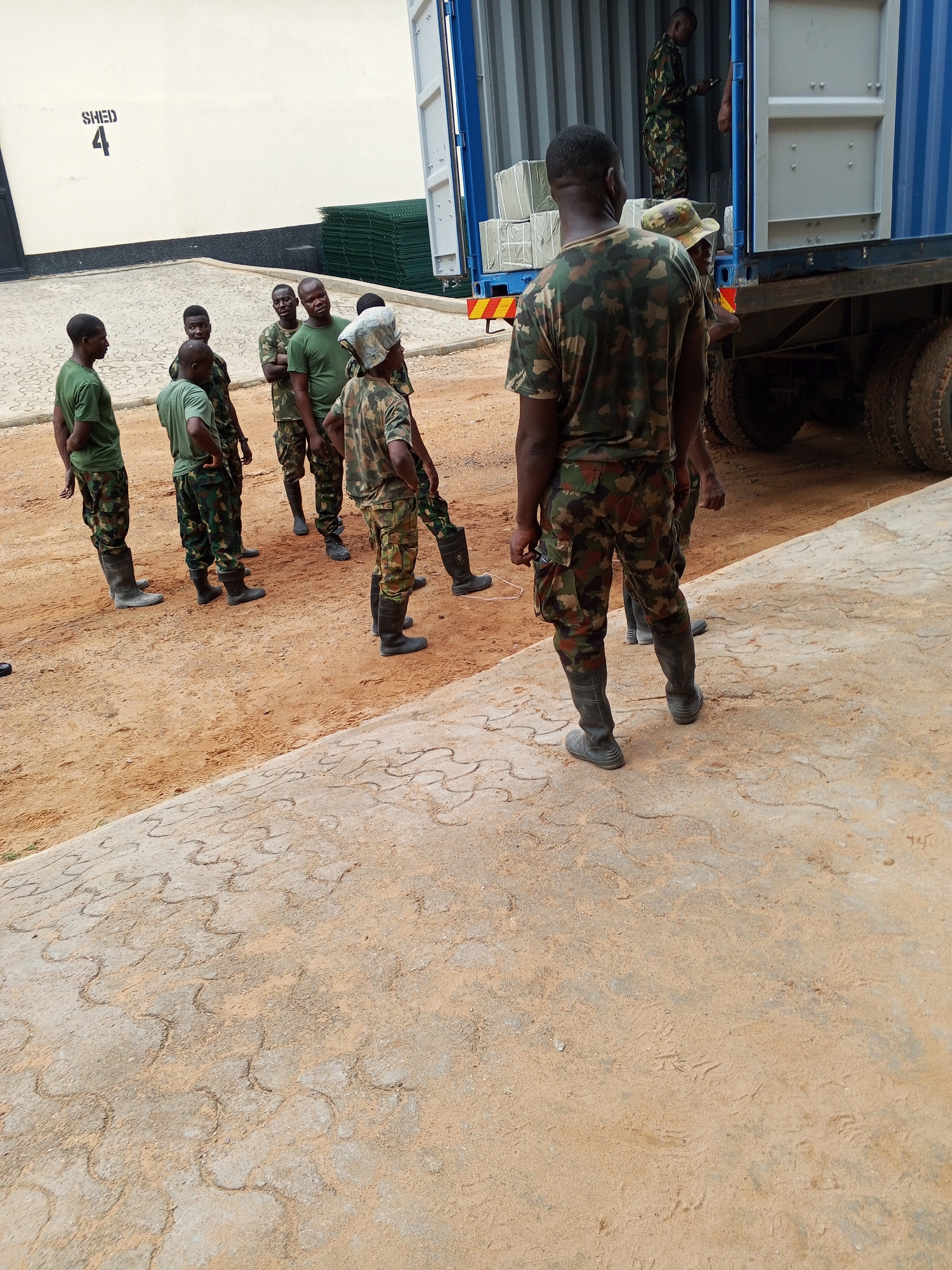 Soldiers gather in Pasere, Nigeria near shipping container