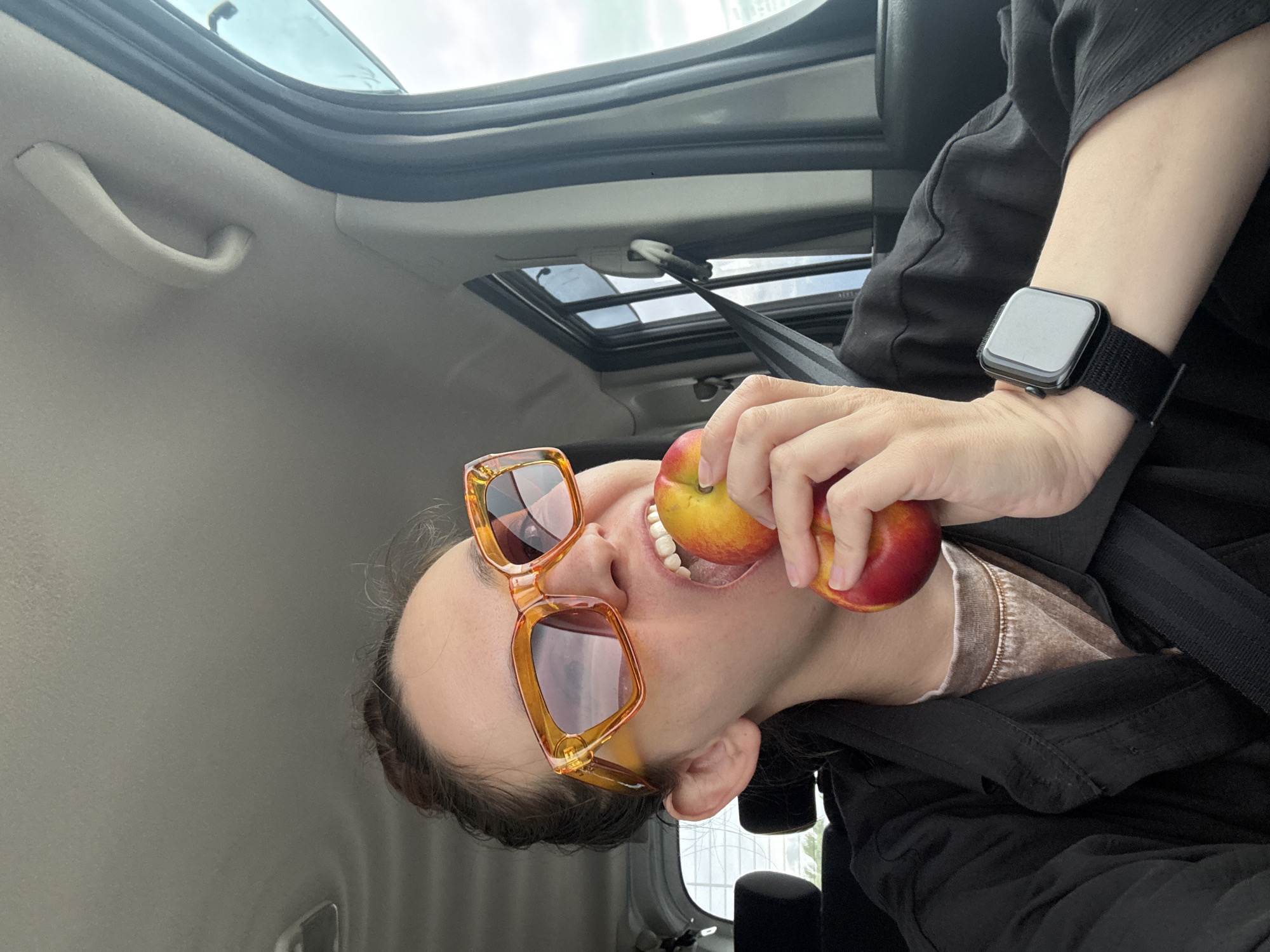 Traveler poses playfully with fruit during Russian road trip