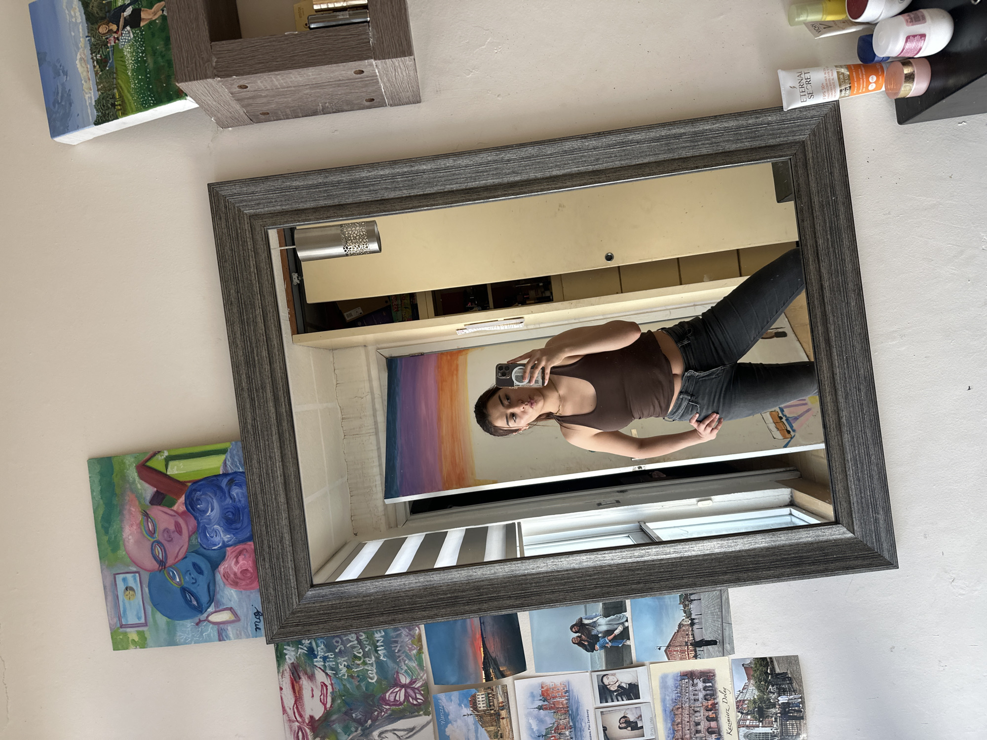 Woman takes mirror selfies in bedroom in Puebla