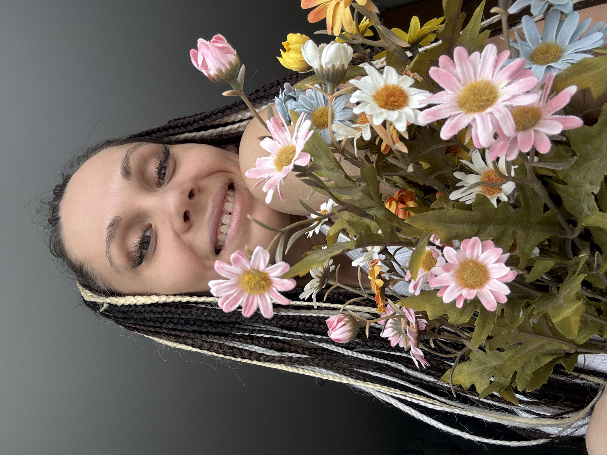 Woman holds colorful artificial flower bouquet in Rusanovo