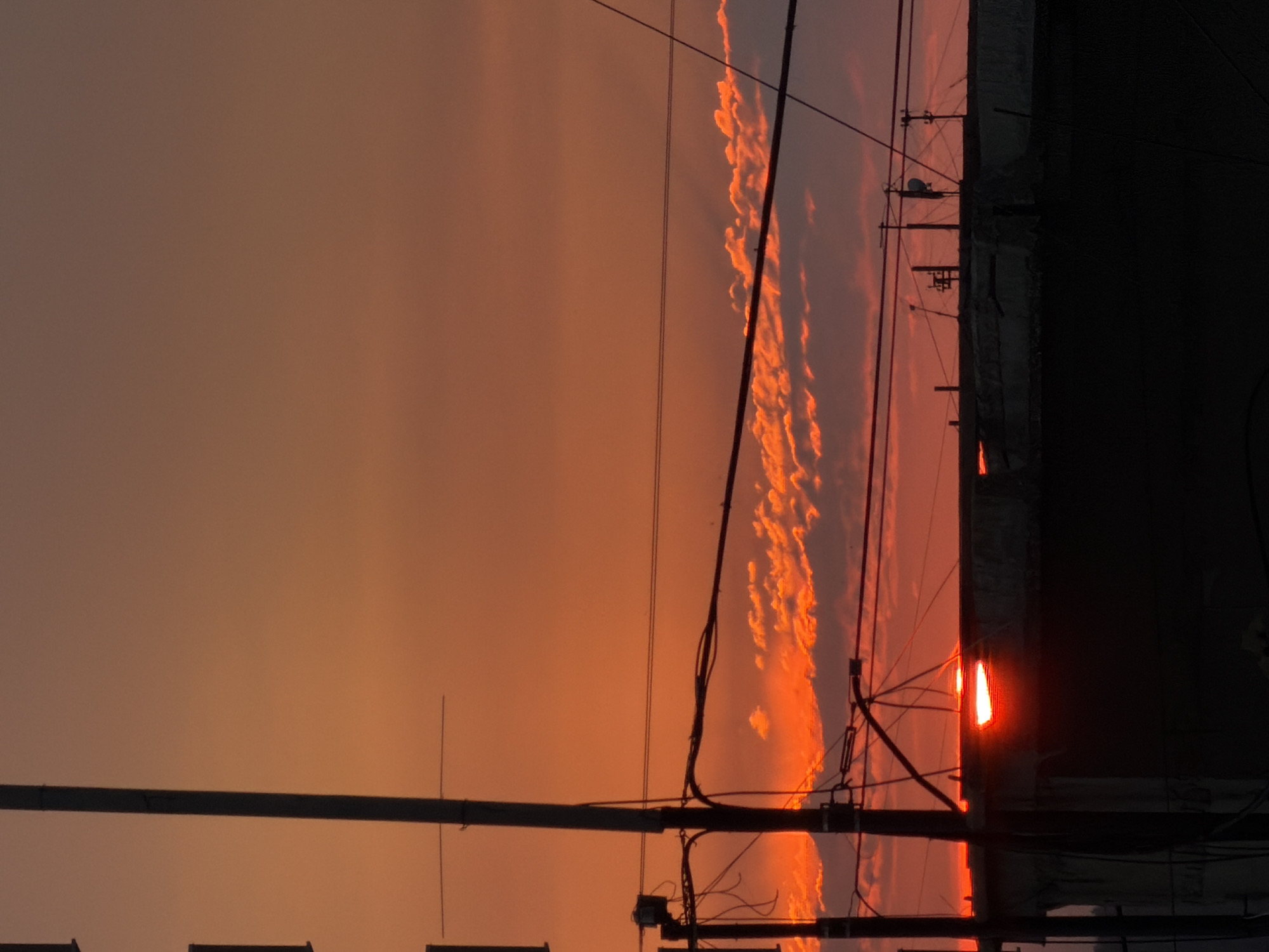 Bold orange sunset behind Perm's urban skyline