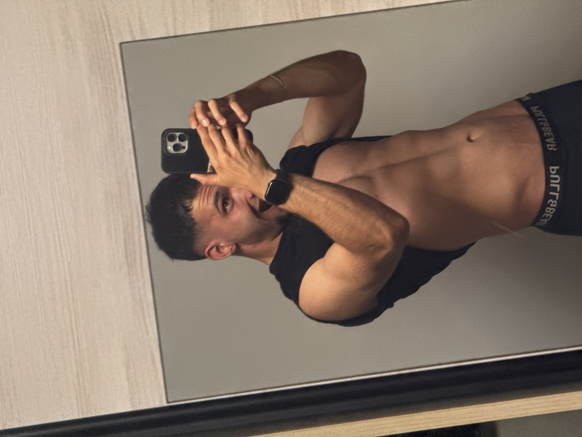 Young man takes multiple mirror selfies in Shumen bedroom