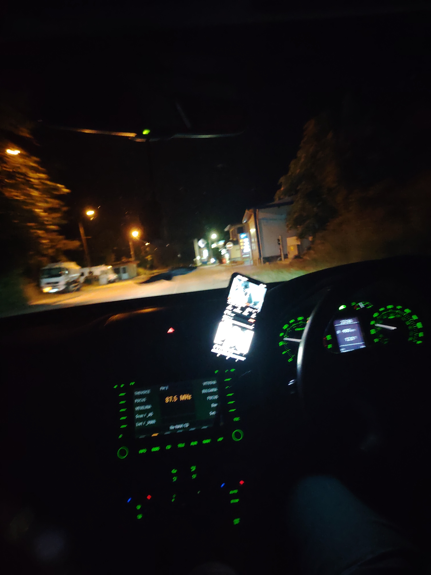 Nighttime driving through Smolyan with illuminated dashboard