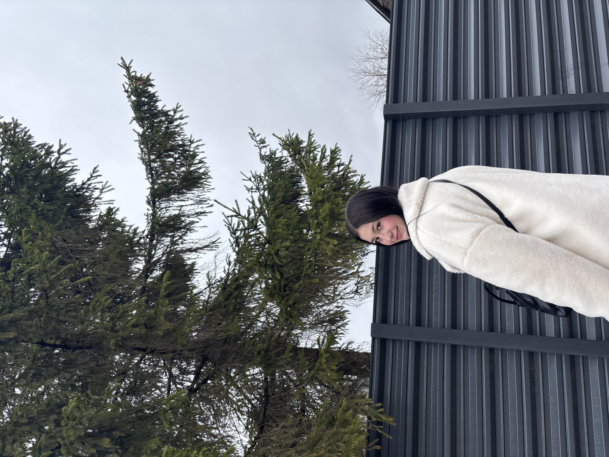 Woman takes selfie in grey sweater in Фоки, Russia