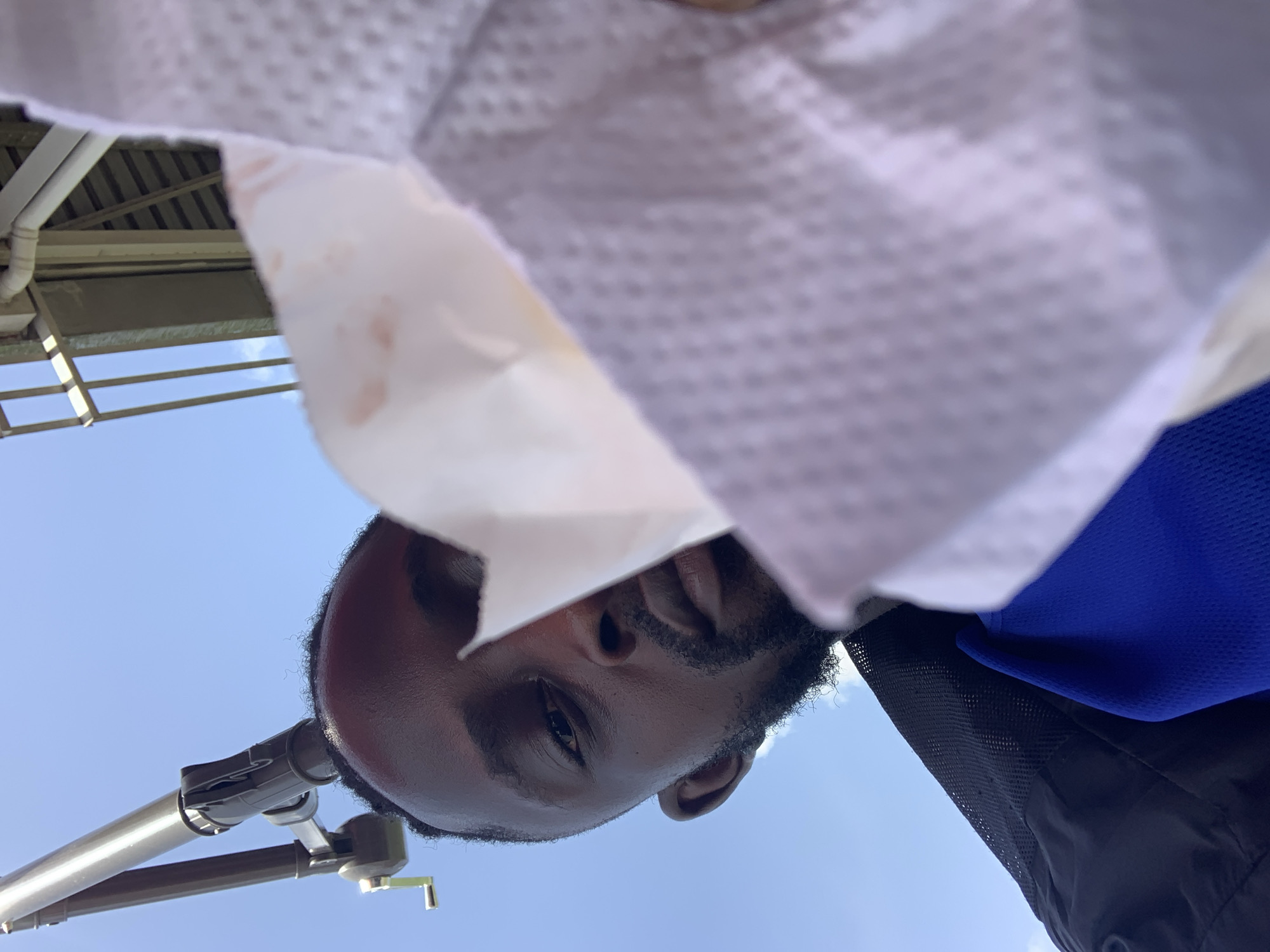 Man enjoys outdoor fast-food meal in Lekki, Nigeria