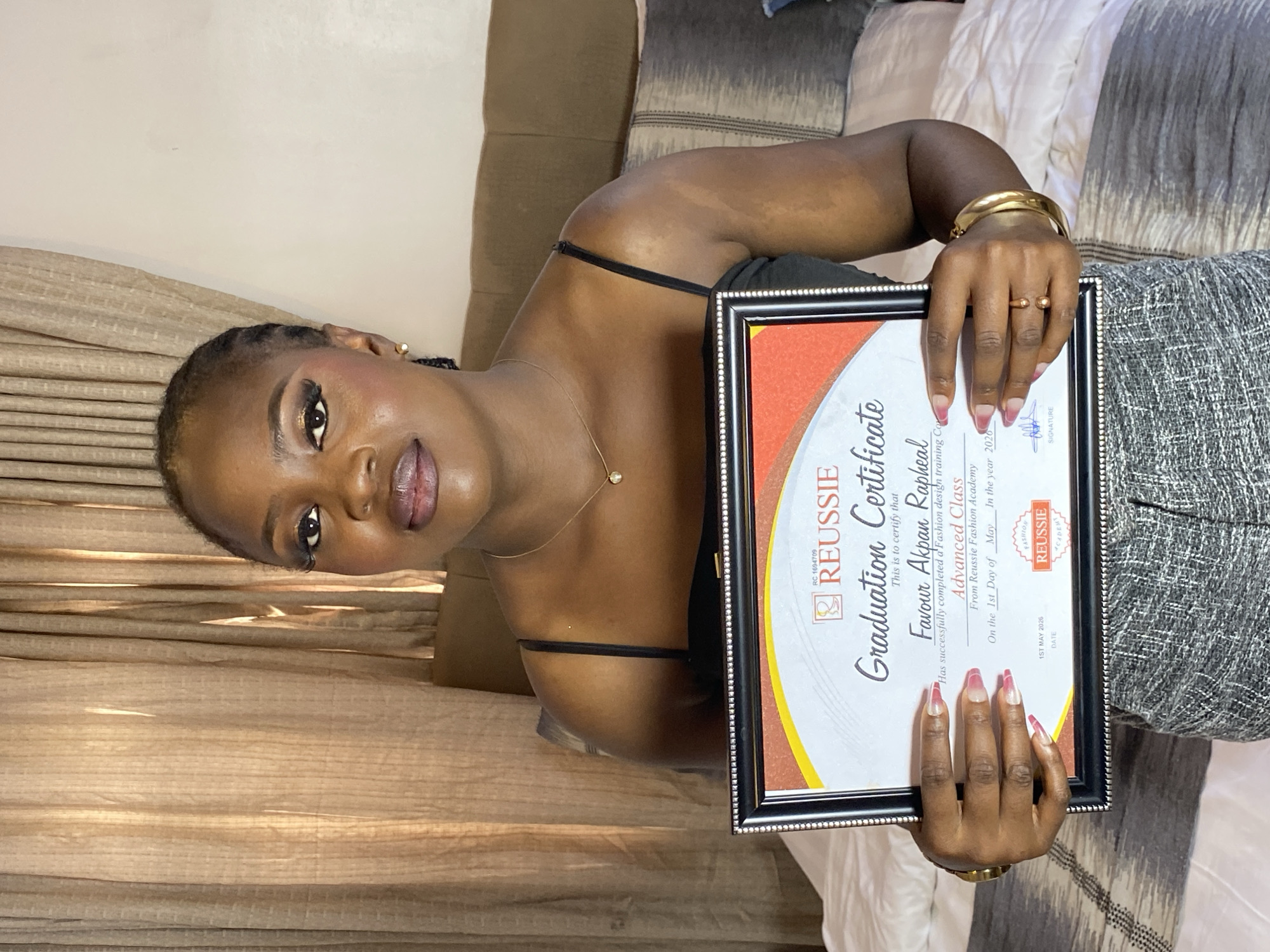 Woman celebrates fashion design graduation in Gura Top, Nigeria