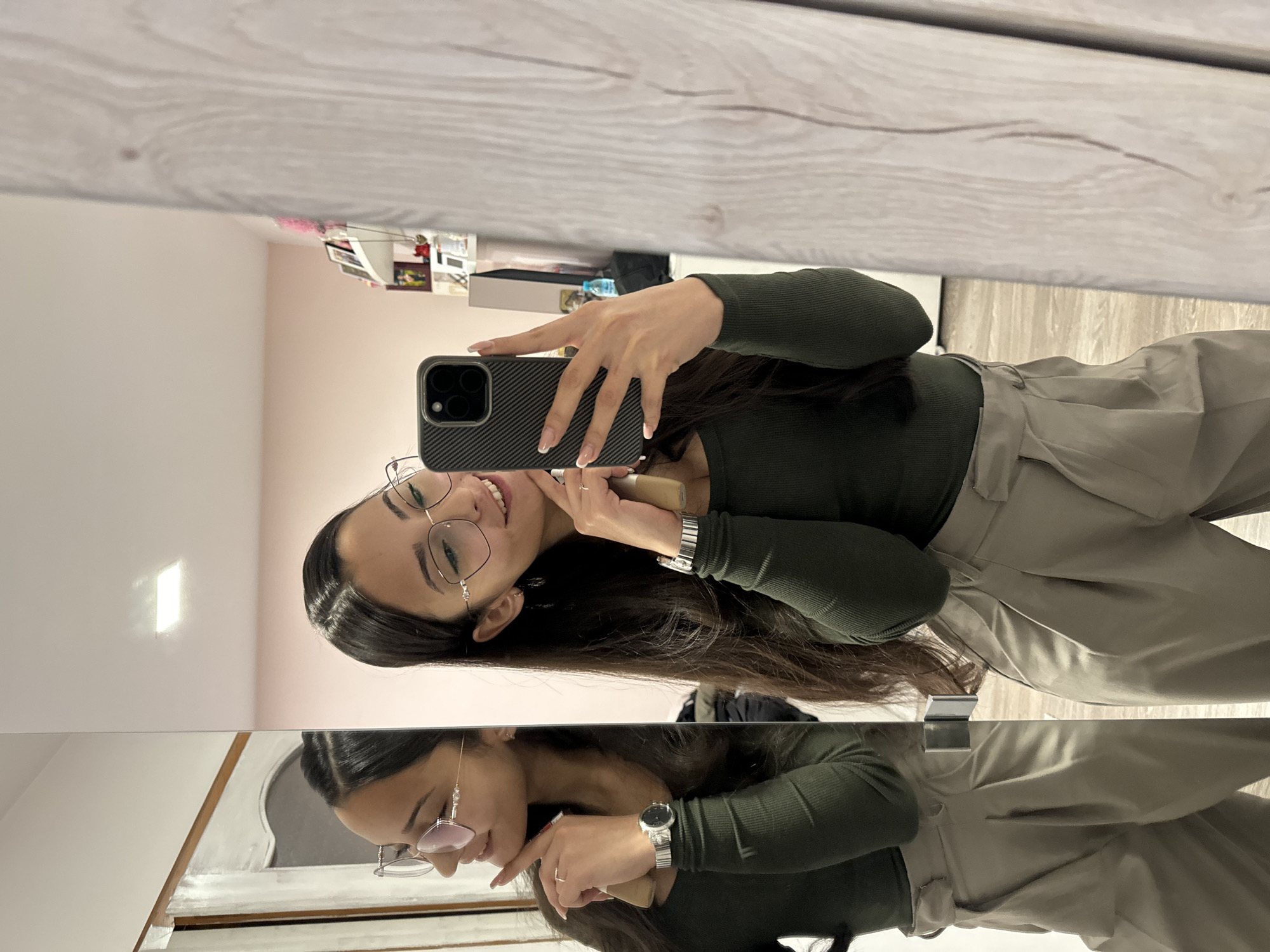 Woman takes mirror selfie while applying makeup in Bulgaria