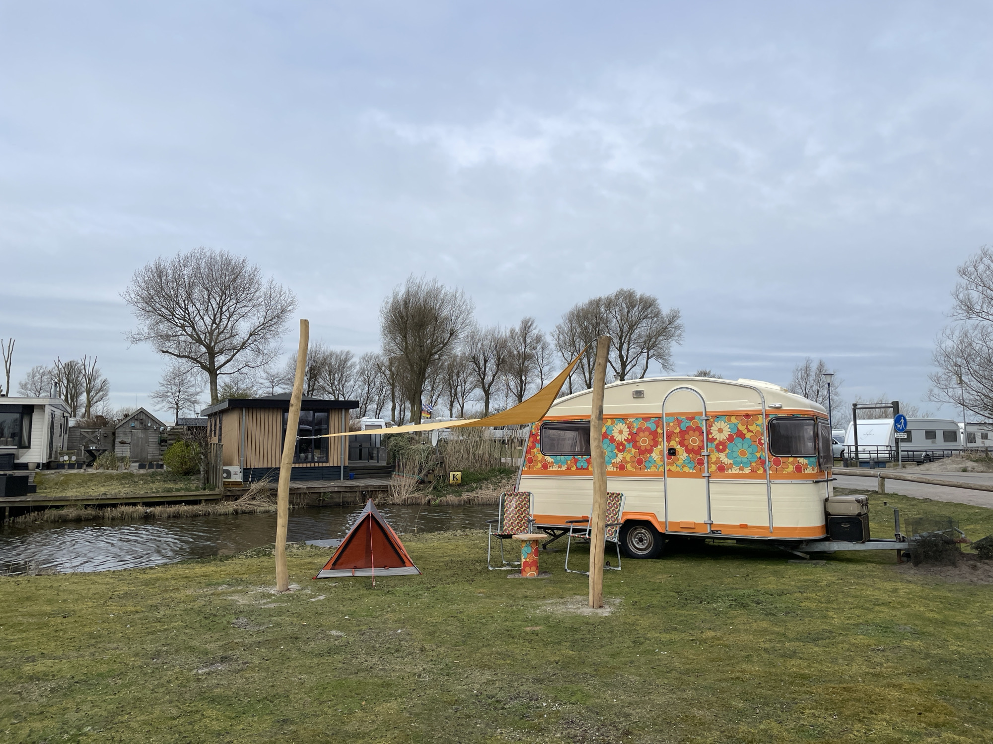 Vintage floral caravan spotted near canal in Makkum
